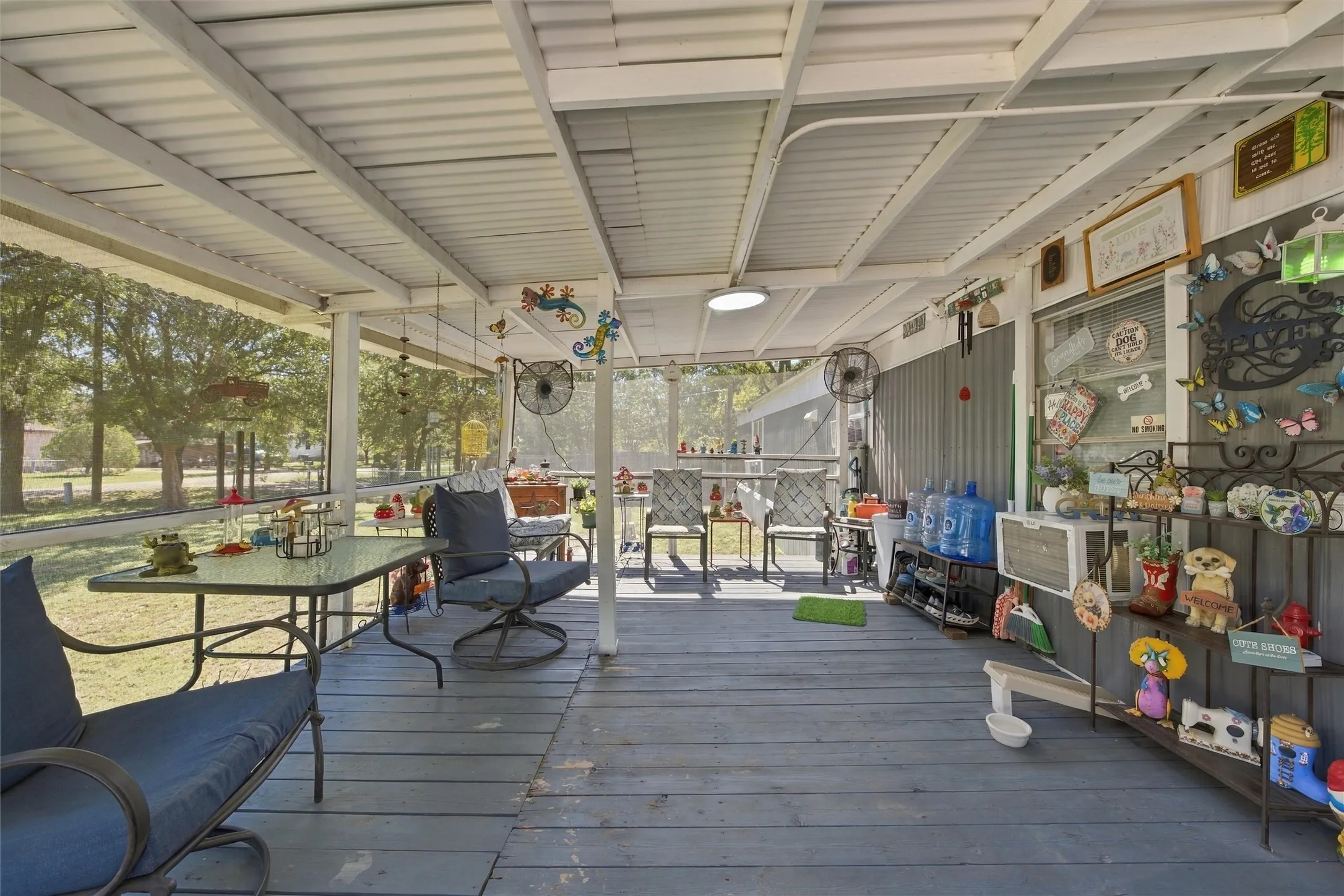 Screened porch with a metal roof and painted wood-finish flooring