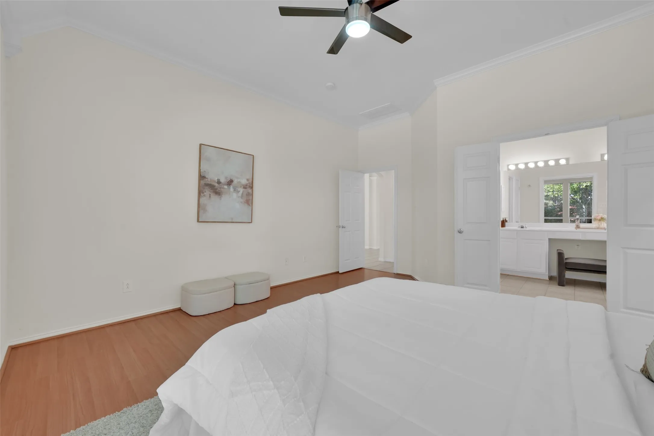 Vaulted ceilings, wood-finish flooring, and a ceiling fan with integrated lighting