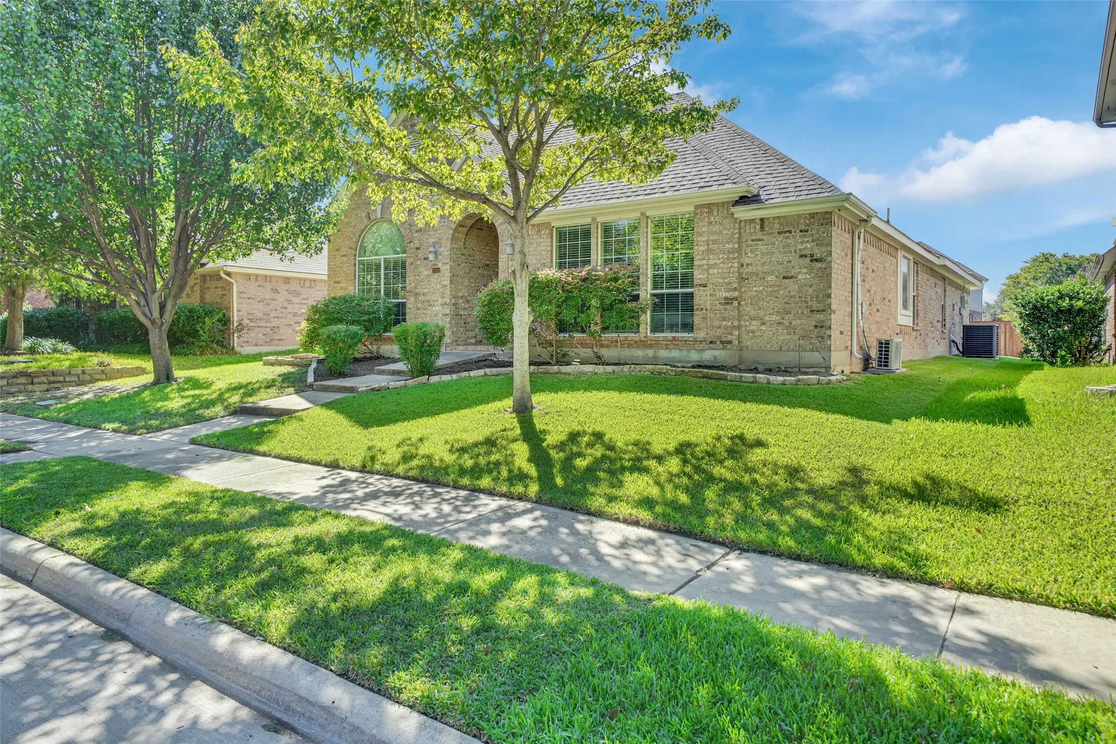 Brick exterior with a gabled roof and arched entry