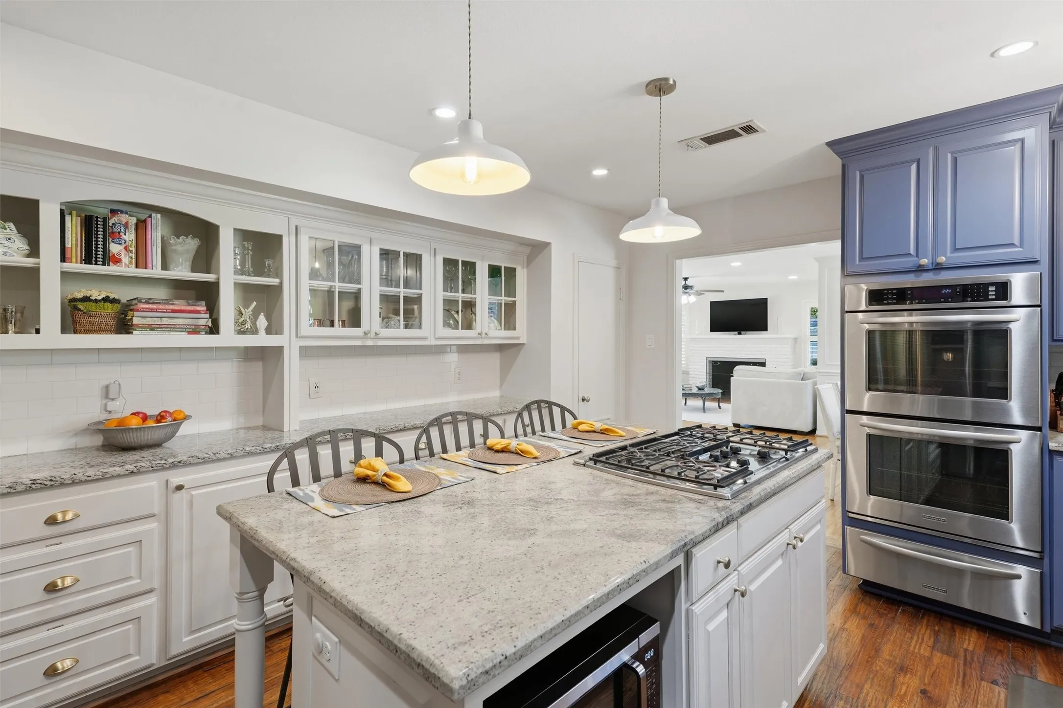 Showcases custom white built-in hutch cabinets with glass front, and tons of storage throughout