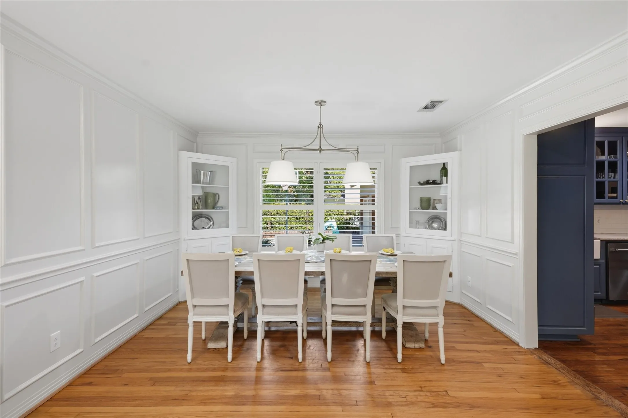 Formal dining area highlighting the timeless wainscoting, built in corner hutches, and great natural light.