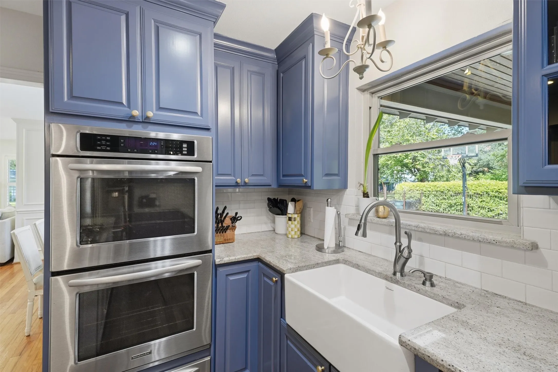 Featuring farm apron sink and gooseneck faucet, and large window for natural lighting, plus double ovens!