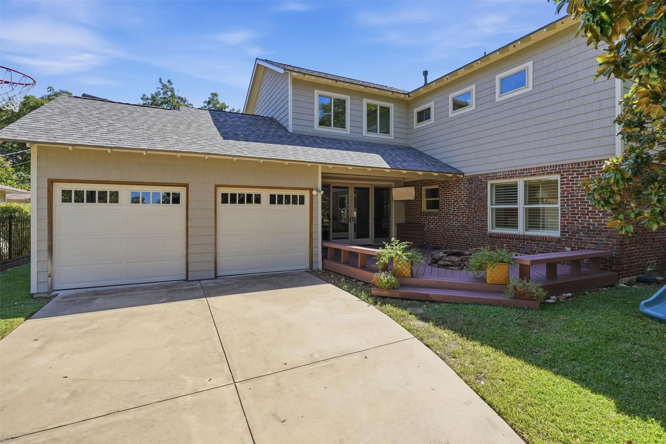 Great view of the two car, double door garage. Large outdoor deck with firepit, perfect for family gatherings.
