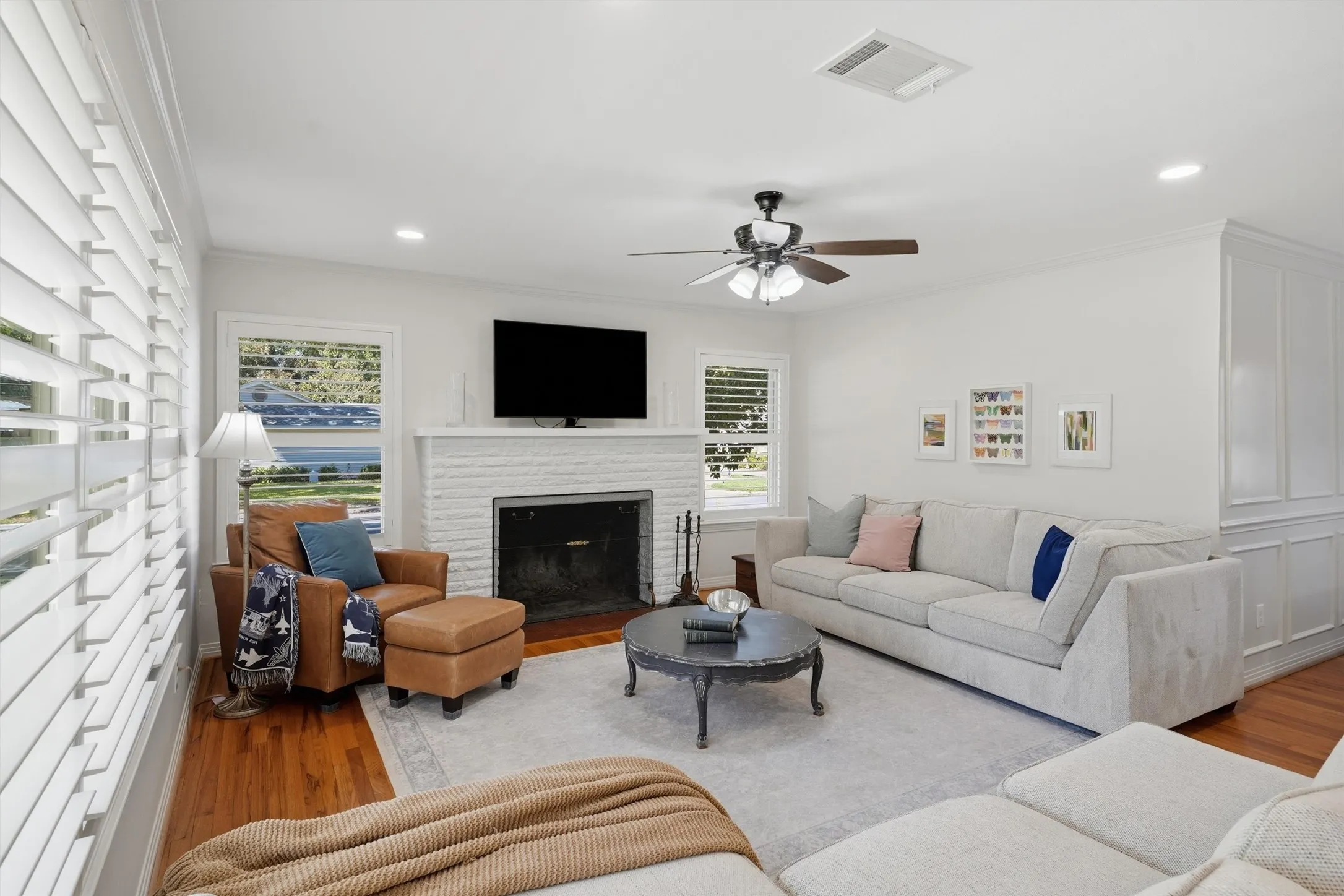 Living room featuring beautiful white fireplace perfect for family gatherings.