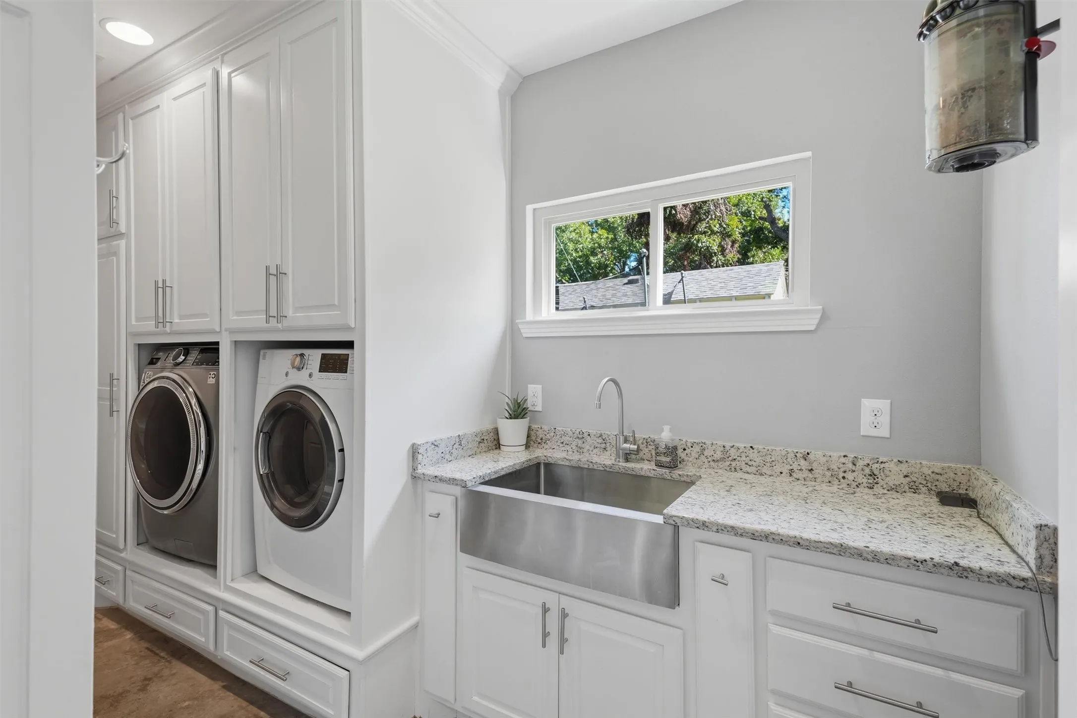 Laundry room featuring built-ins as well as soaking/folding station.