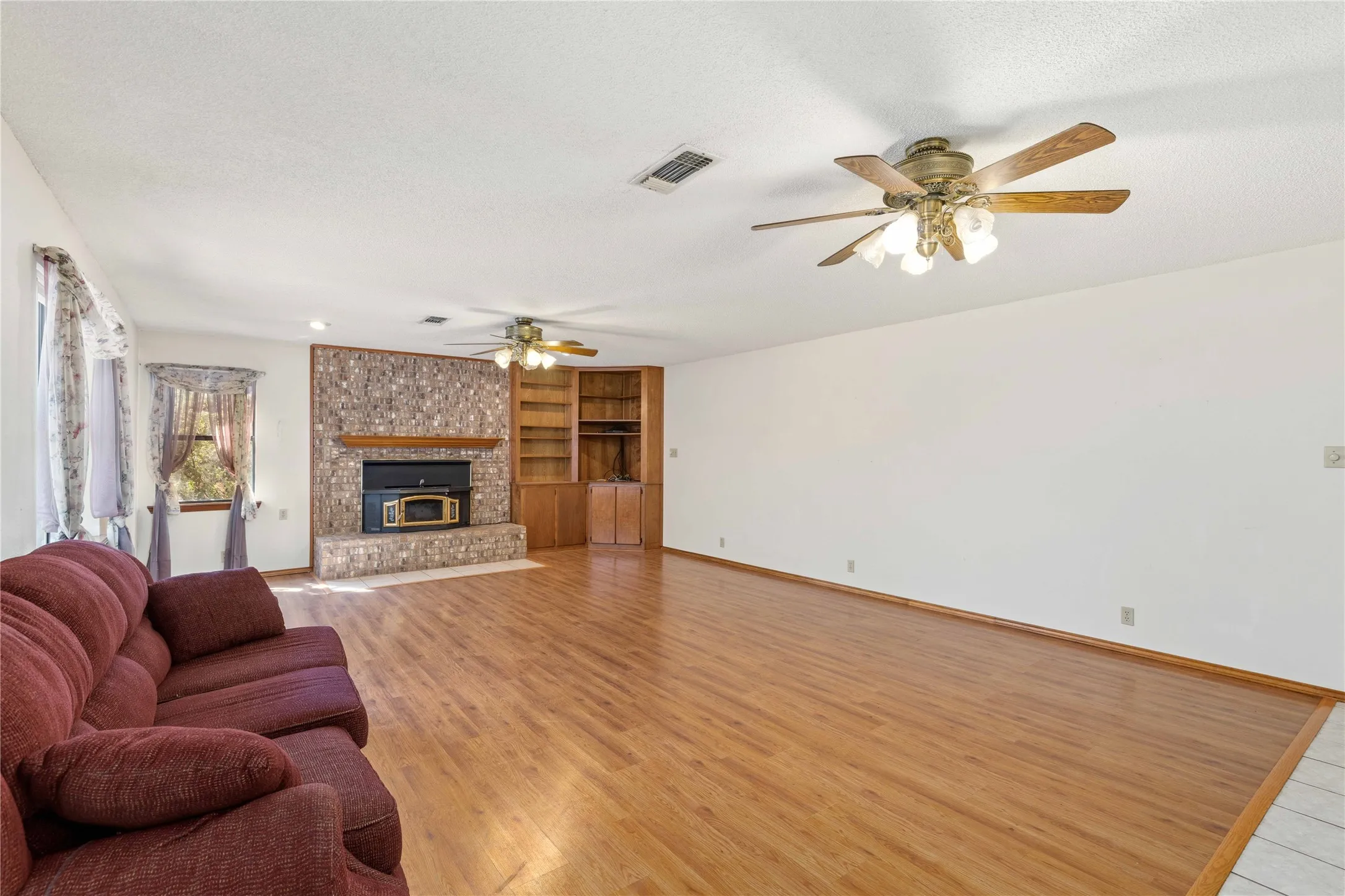 Large living room with built in shelves, Windows that allow views of Lake Brownwood and a Wood burning Fireplace