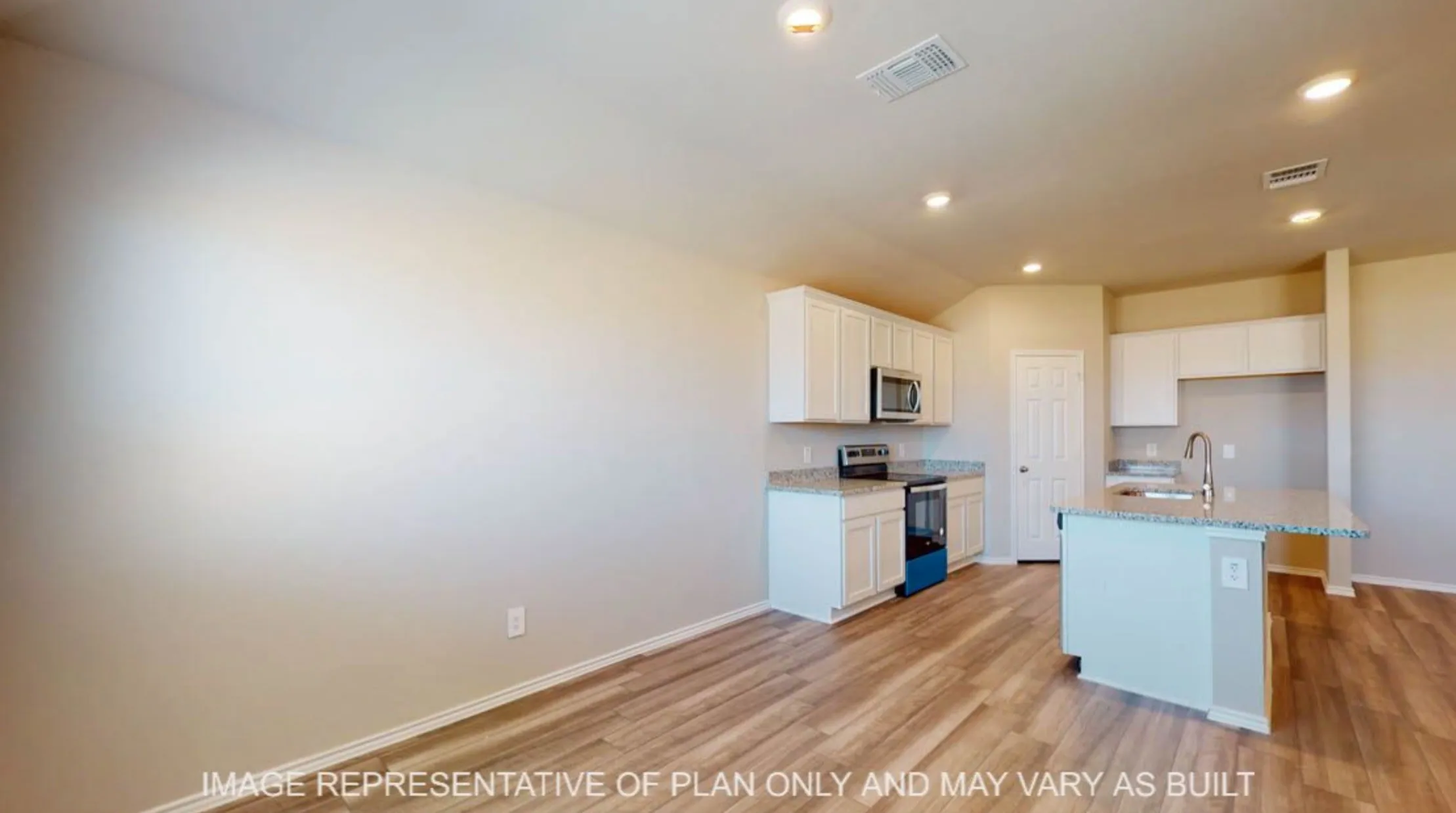 Wood-finish flooring throughout, white cabinetry, integrated stainless steel microwave, and recessed lighting