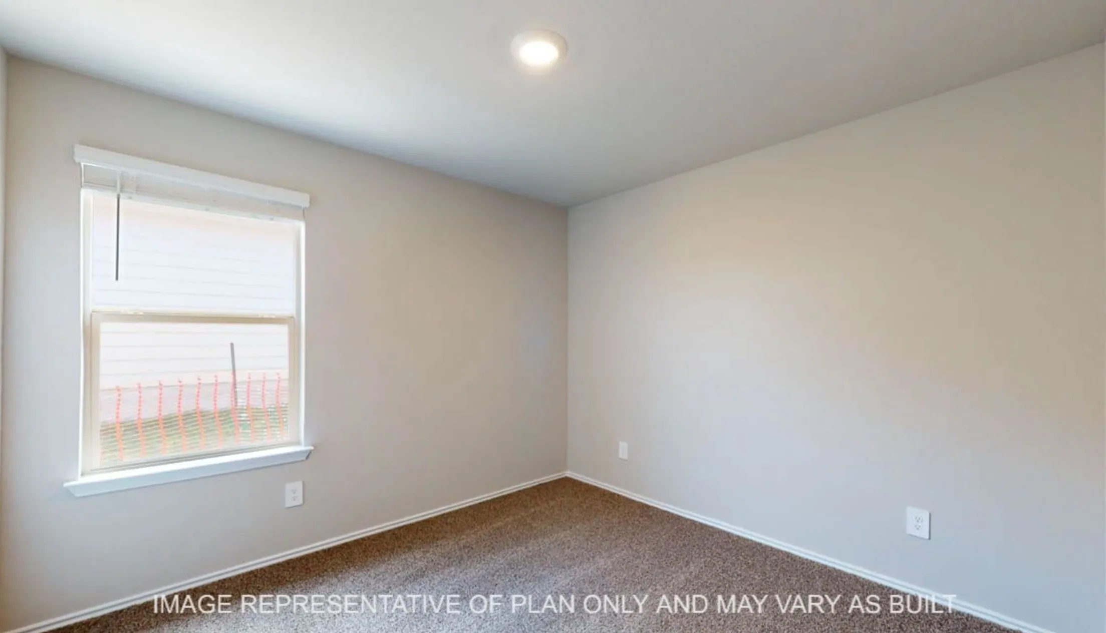 Recessed ceiling light, neutral wall color, window with horizontal blinds, and carpeted flooring