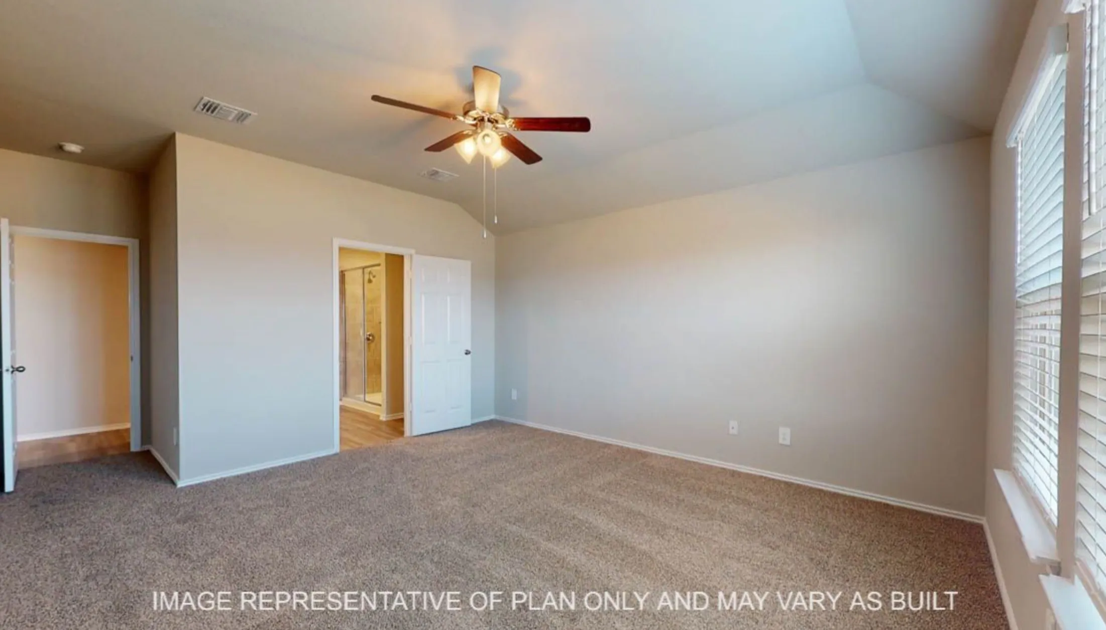 Carpeted room with vaulted ceiling and ceiling fan