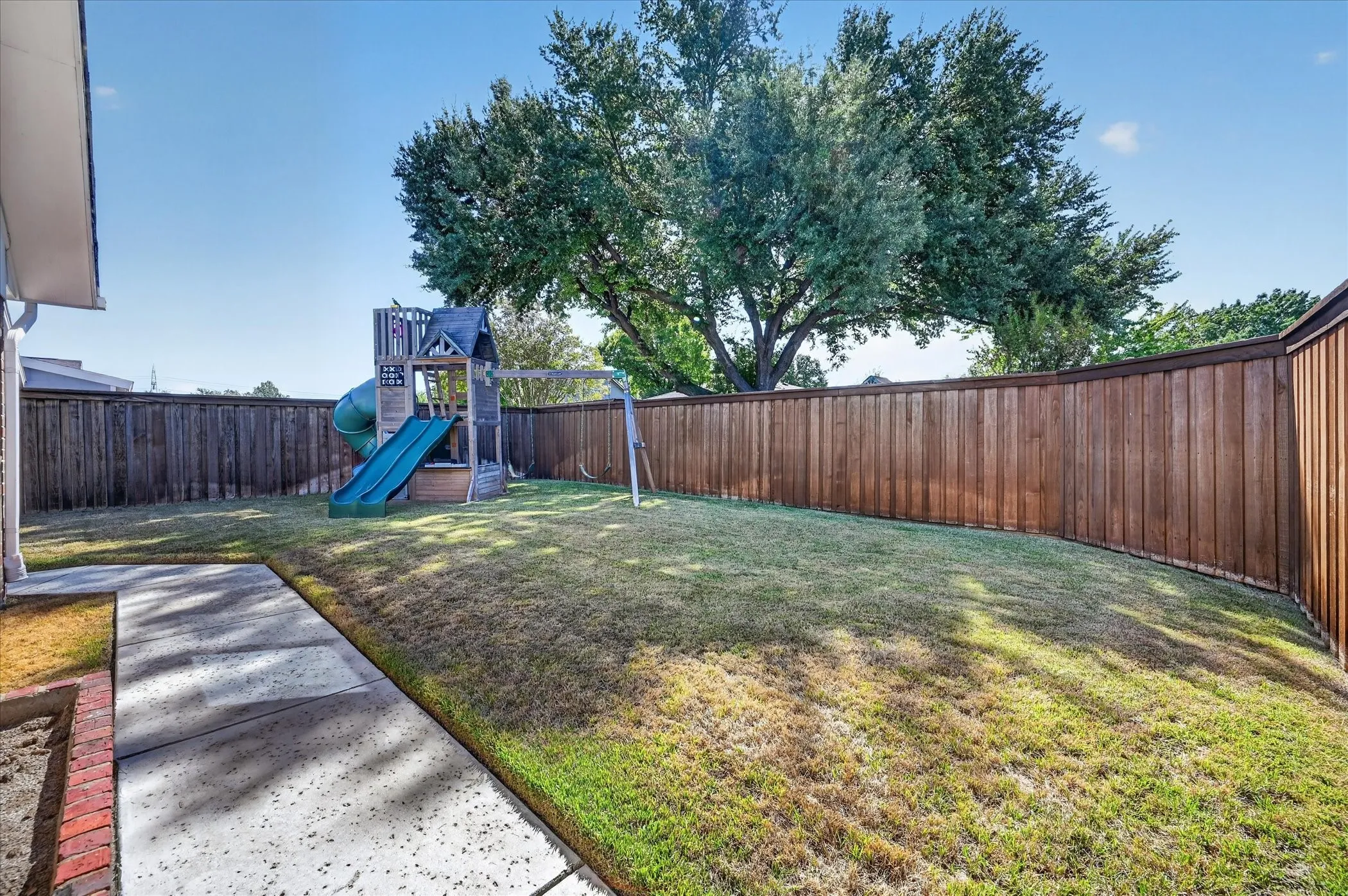 Room to play, garden and enjoy the outdoors, with a cedar privacy fence and a leafy backdrop of mature trees.