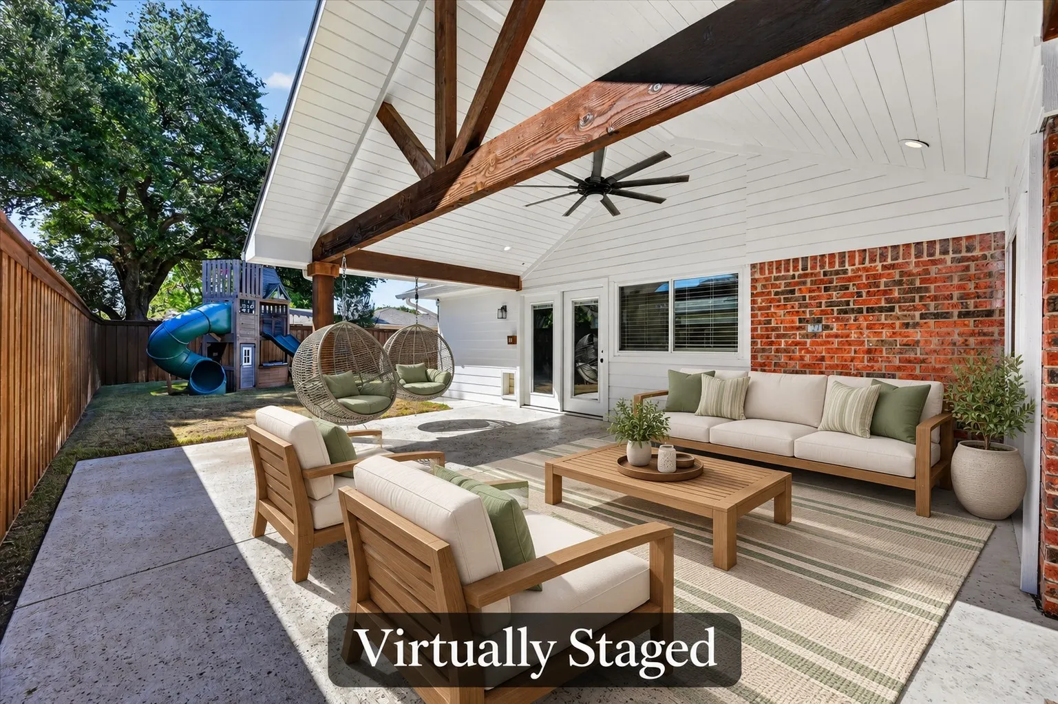 Relax or entertain on this spacious covered patio featuring beautiful wood beams, a vaulted ceiling, and backyard views. Virtually staged.