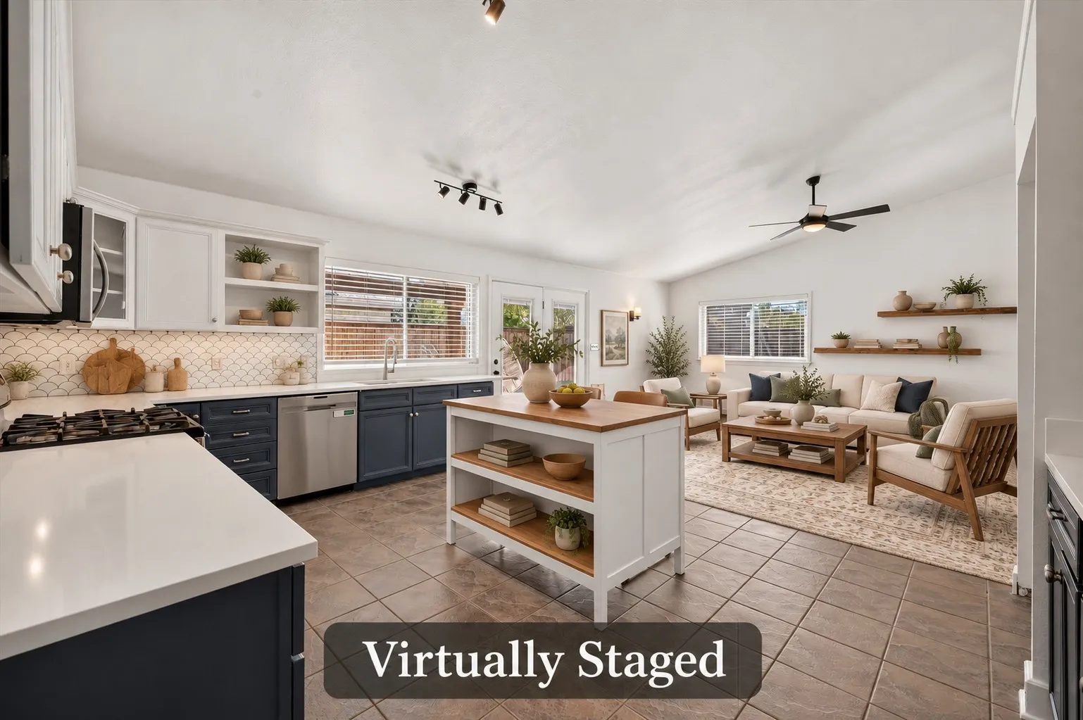 The kitchen opens directly to the comfortable den, keeping conversation flowing while meals are prepared. Virtually staged.