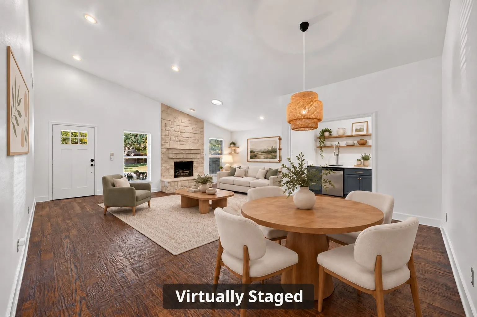 Hand-scraped hardwoods and decorator lighting bring warmth and character to the dining area overlooking the step-down living room. Virtually staged.