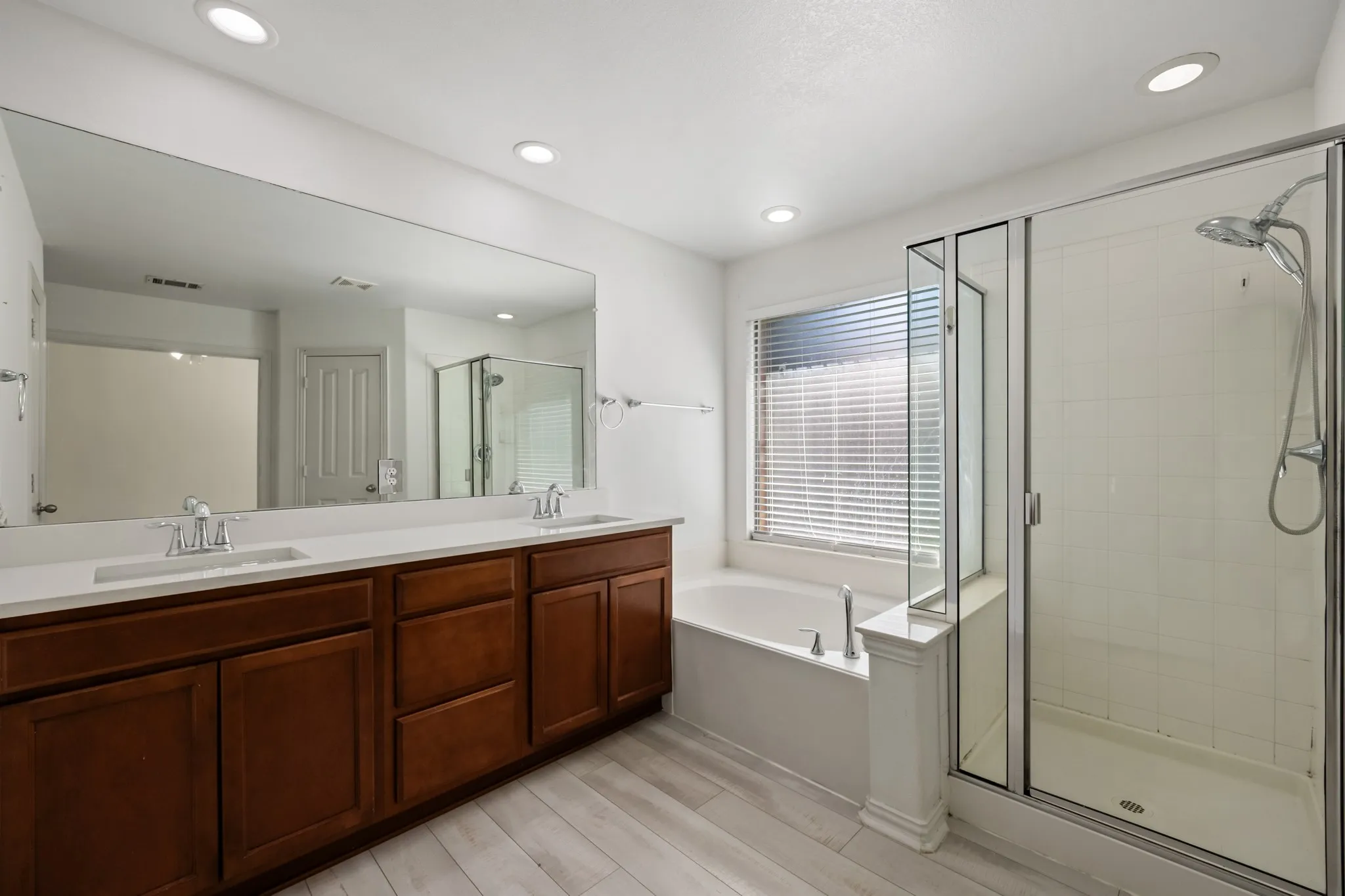 Dual vanity with undermount sinks and wood cabinetry