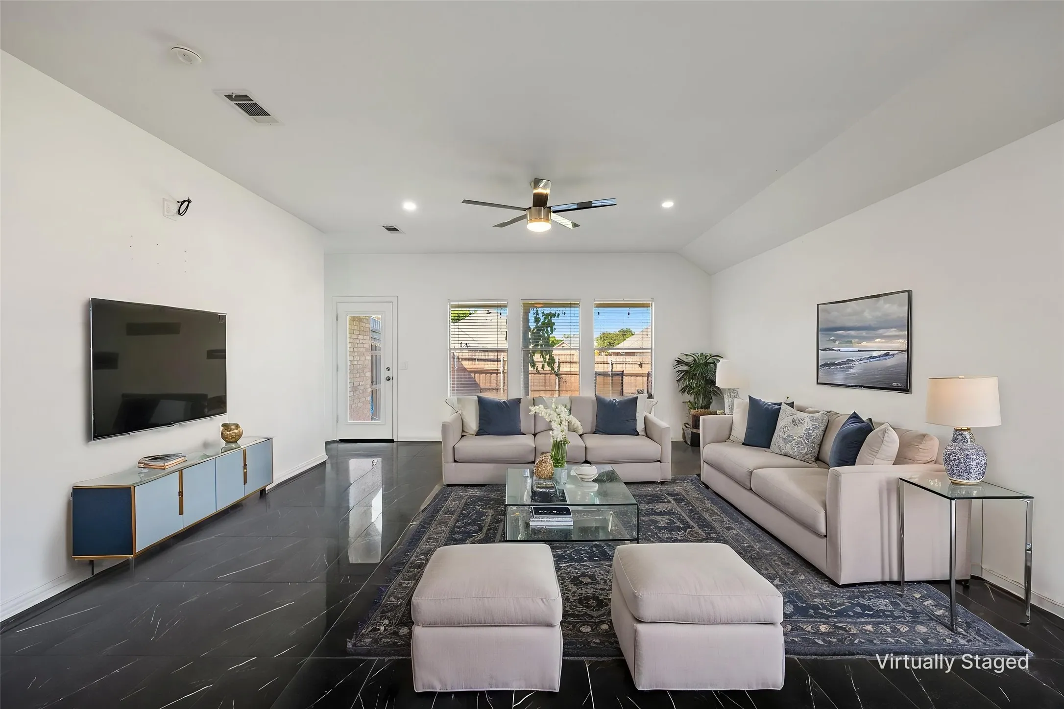 Vaulted ceiling with recessed lighting and ceiling fan