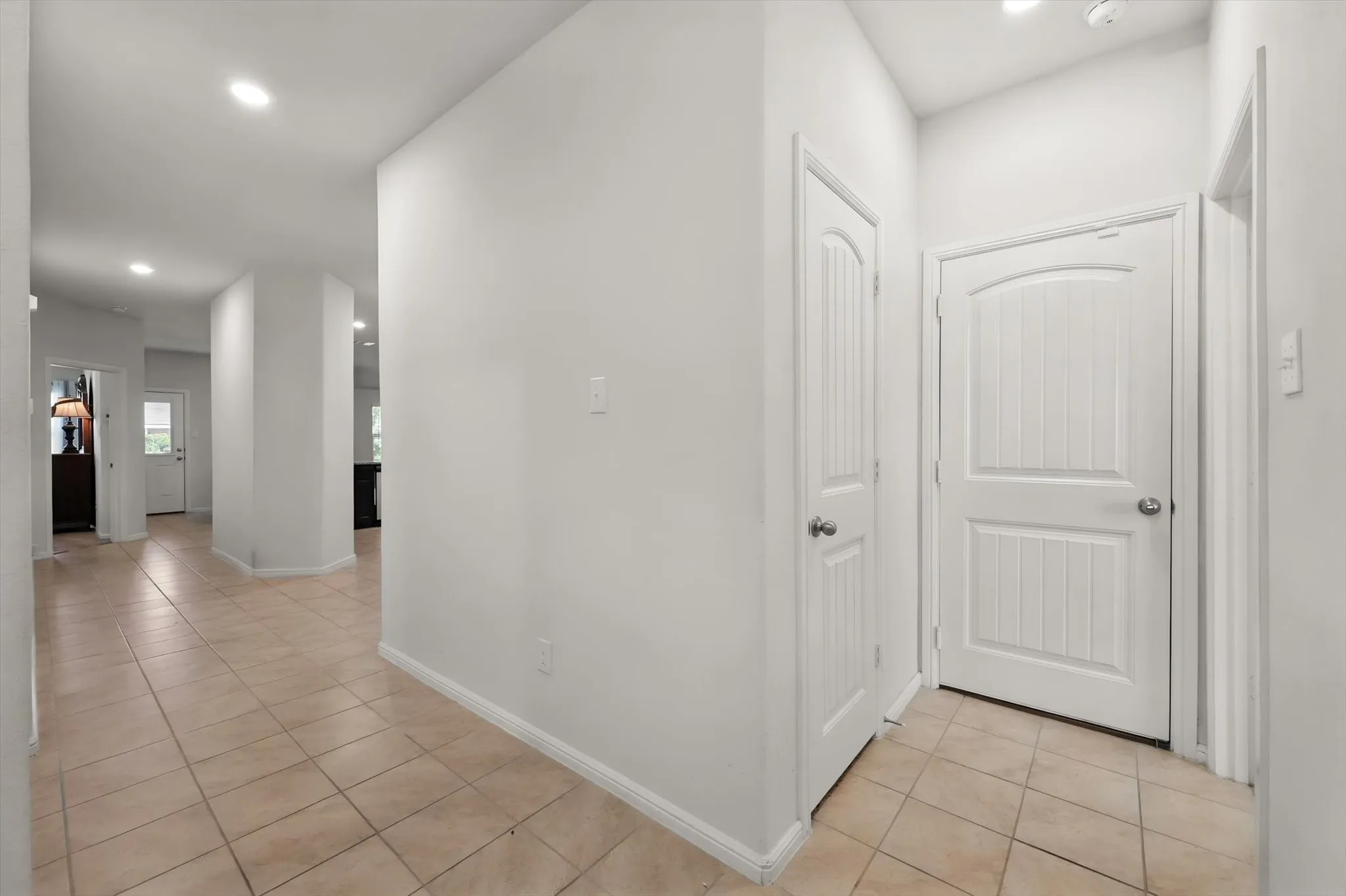 Tiled flooring throughout, recessed ceiling lighting, and solid interior doors
