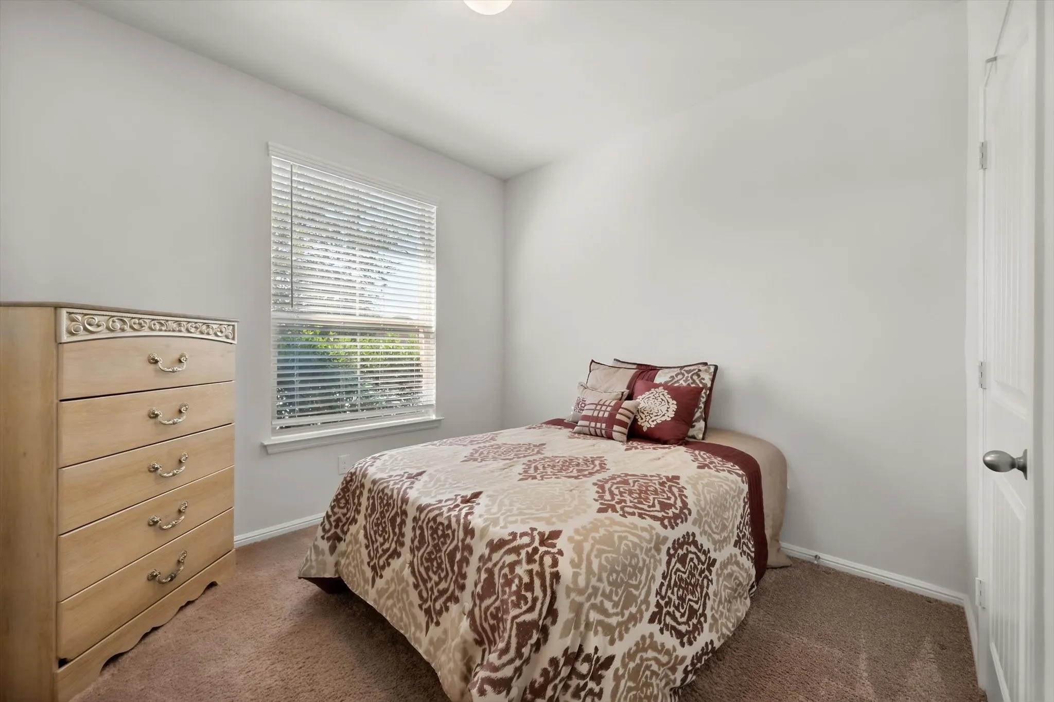 White painted walls with a window featuring horizontal blinds