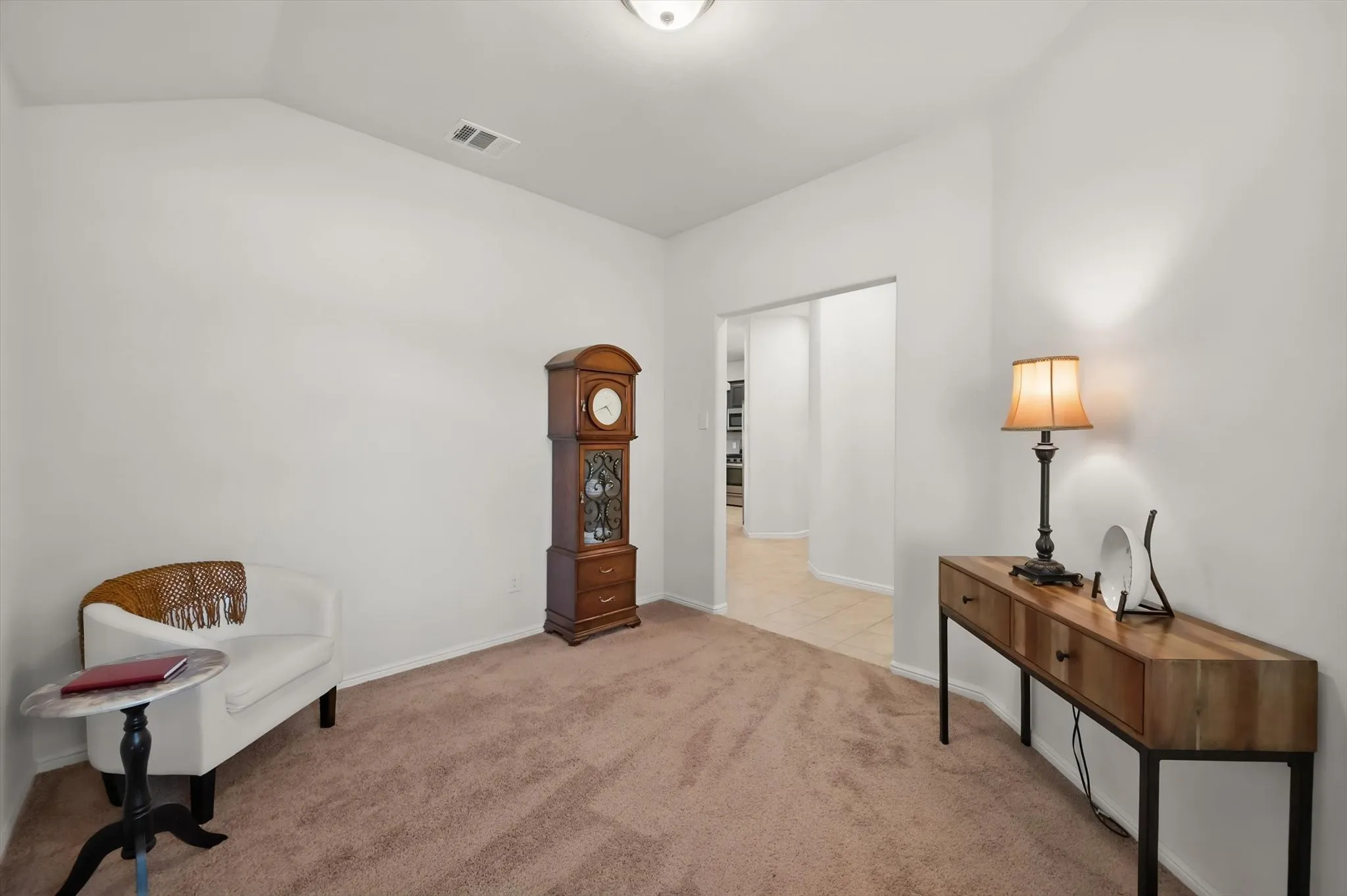 Neutral wall finishes, recessed lighting, and carpeted flooring