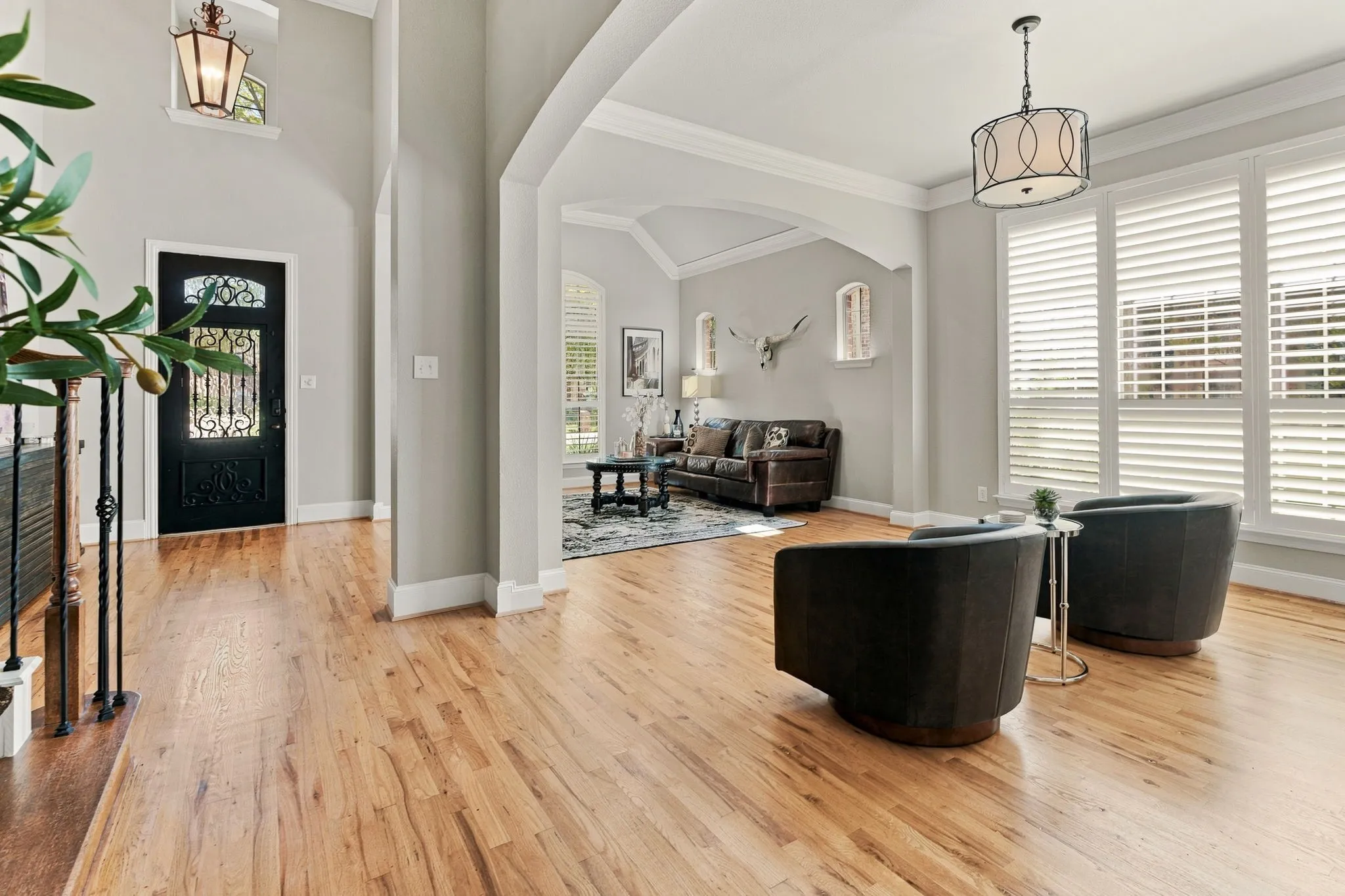 Formal Dining Room | Currently arranged as a sitting area, this front room features wood flooring, a chandelier, large windows and access to the foyer.