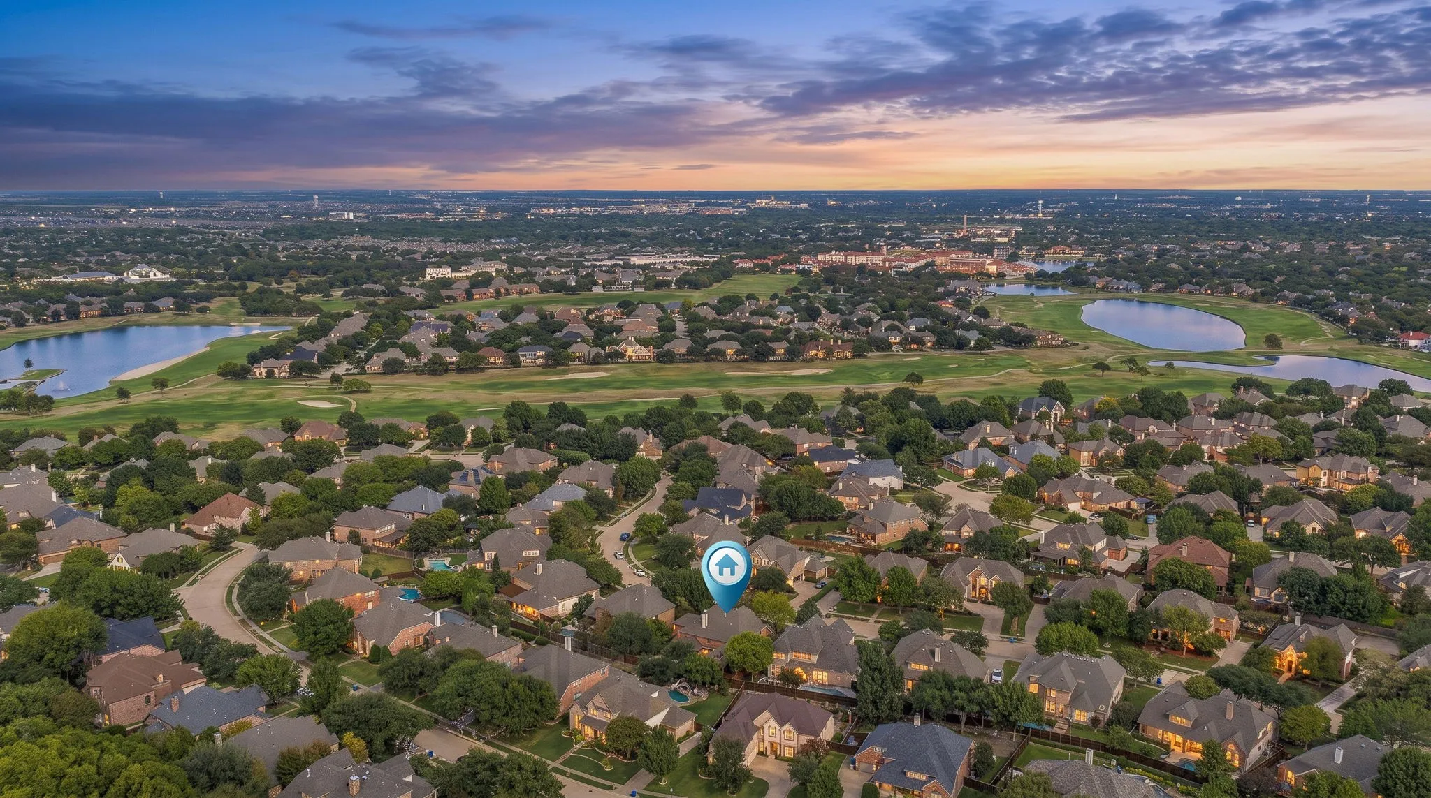 Stonebridge Ranch Aerial View | Twilight neighborhood perspective shows the home's setting among tree-lined streets in McKinney.
