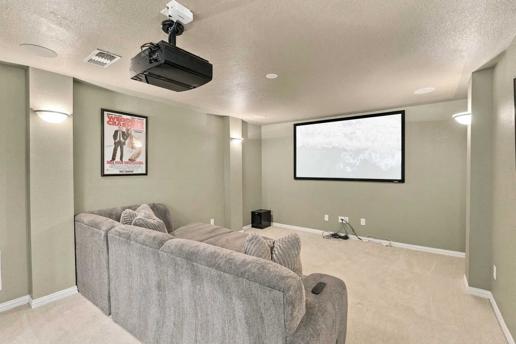 Dedicated Media Room | Upstairs media space with a projection screen, ceiling-mounted projector and room for comfortable movie-night seating.