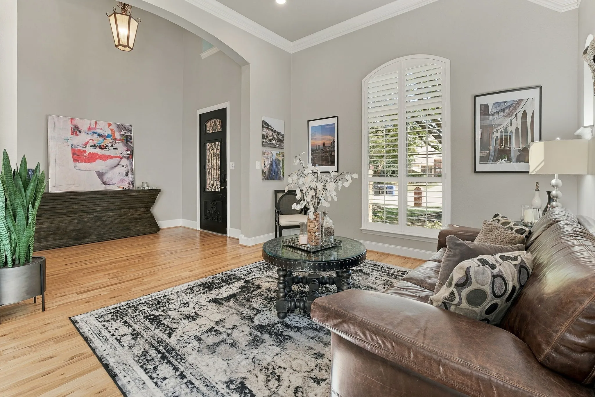 Formal Living Room, Alternate View | Tall windows, recessed lighting and wood flooring define this flexible front living area near the foyer.
