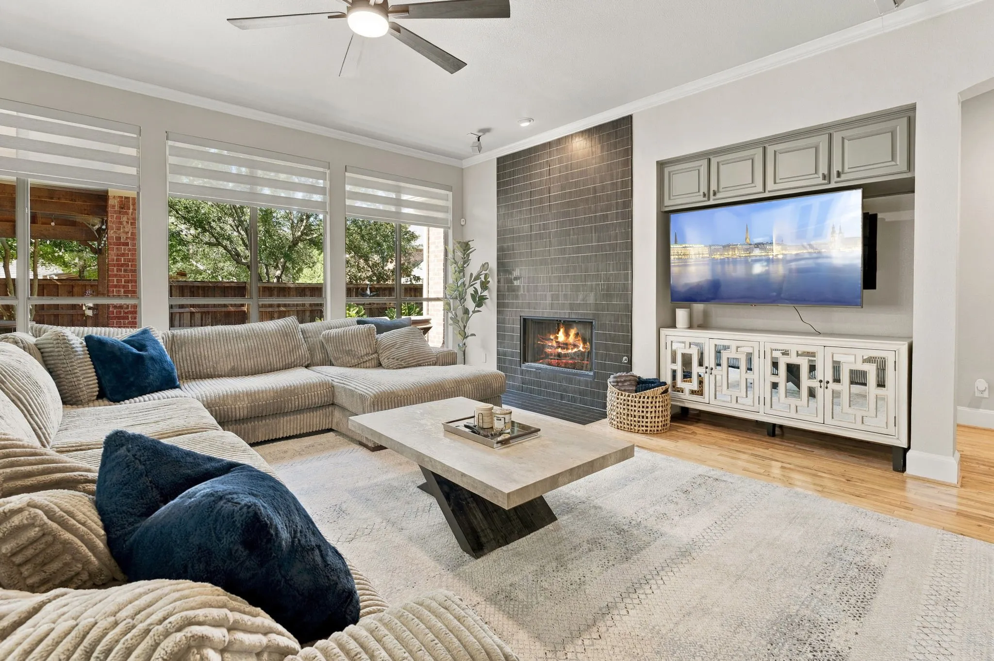 Family Room | Main living area with a newly tiled fireplace, built-in cabinetry and large windows overlooking the backyard pool.