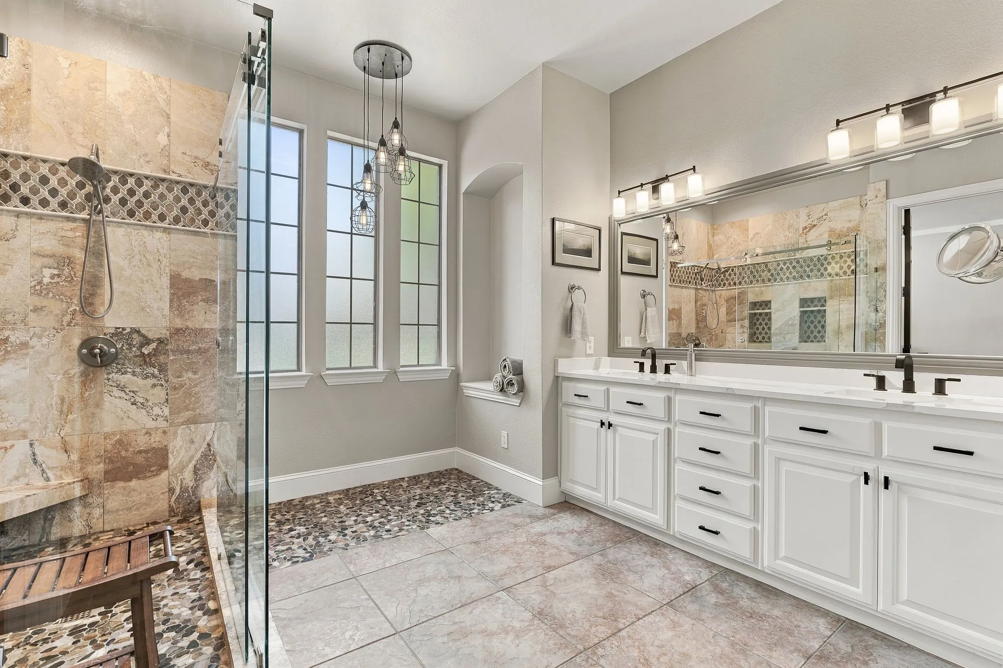 Primary Bathroom | Dual-sink vanity, extensive storage and a large glass-enclosed shower create a spacious primary bath.
