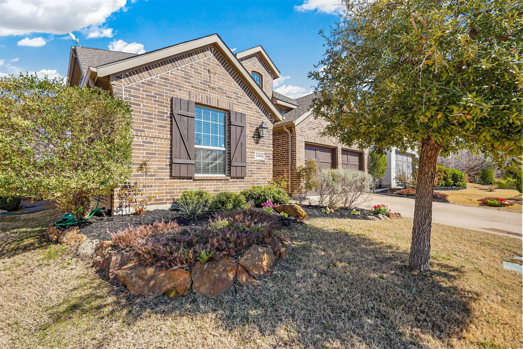 Brick exterior with wood-tone shutters