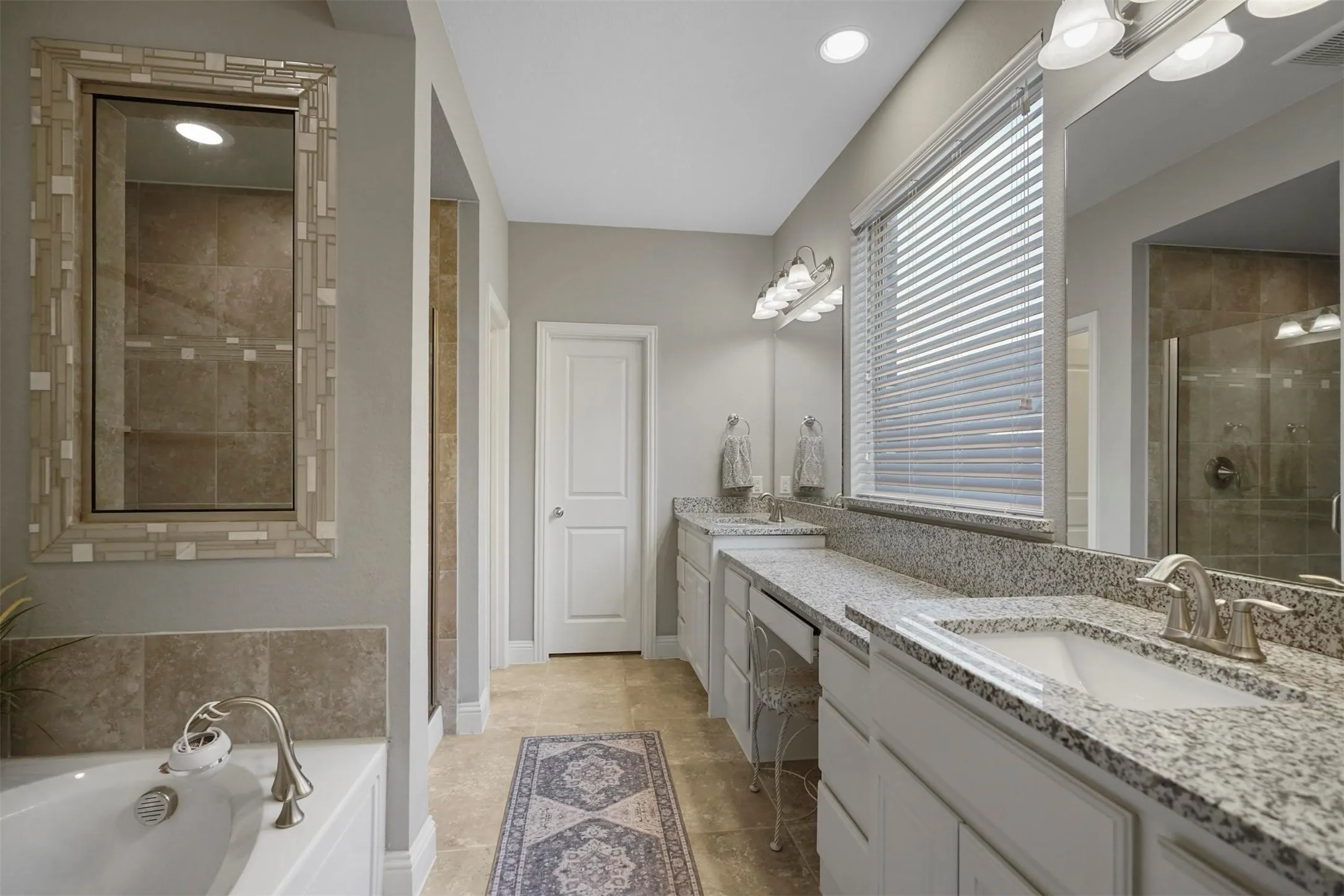 Dual vanities with granite countertops and undermount sinks