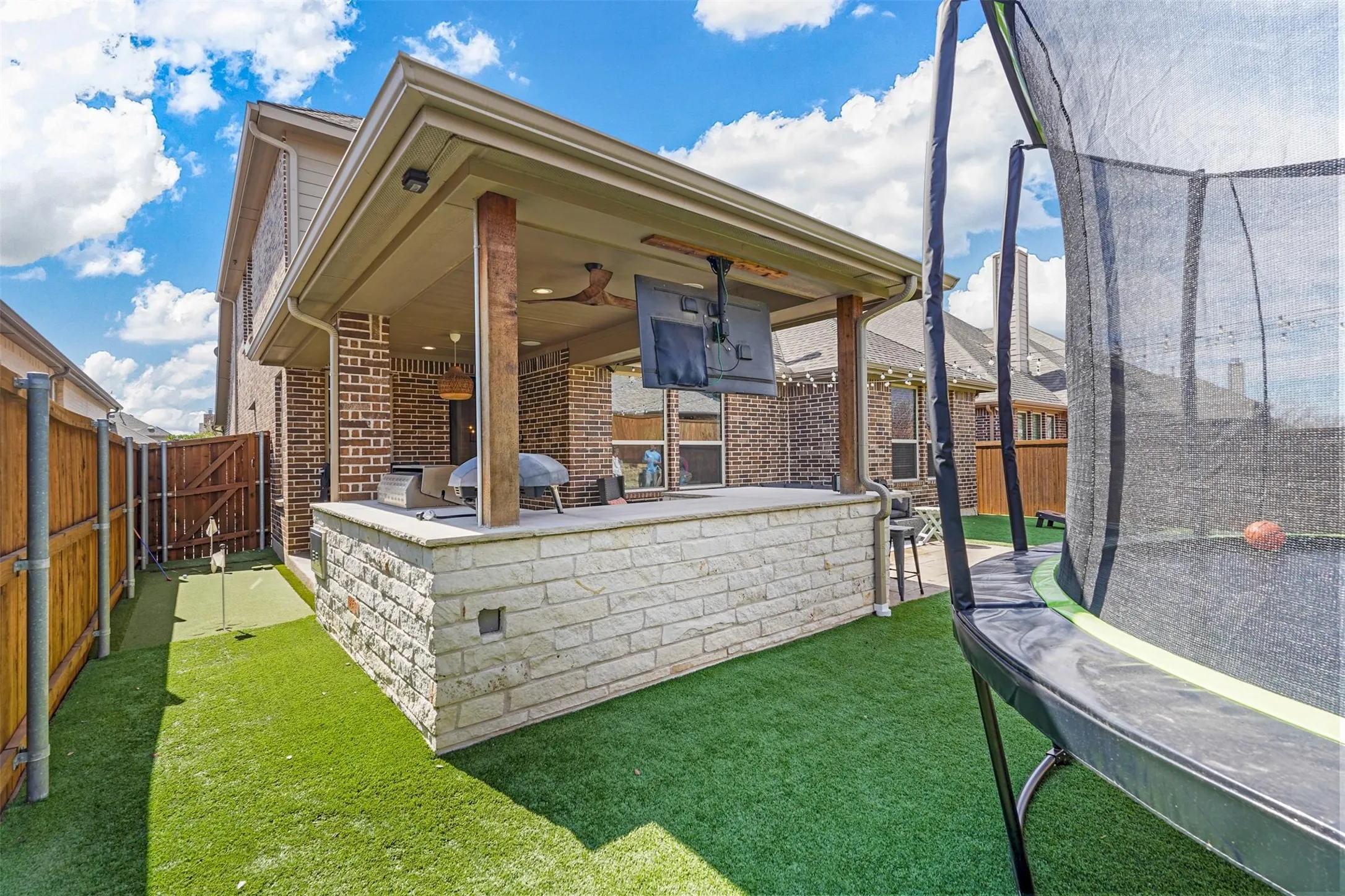 Covered patio featuring a ceiling fan, recessed lighting, and a mounted television