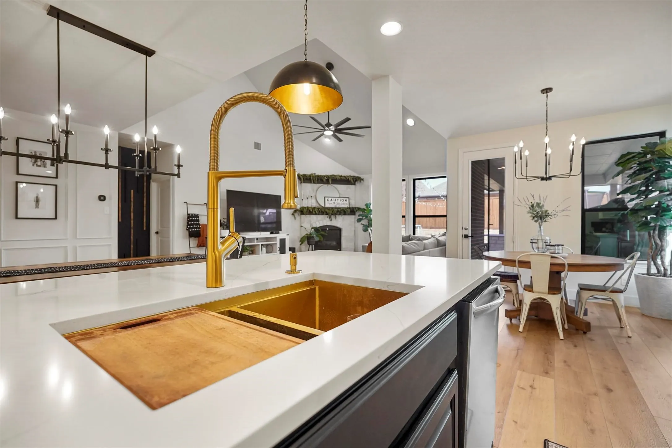 White countertop island with integrated gold-tone sink and modern brass faucet