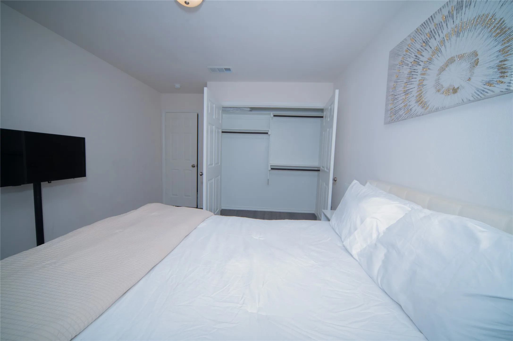 Recessed ceiling light, white painted walls, and bi-fold closet doors with interior shelving