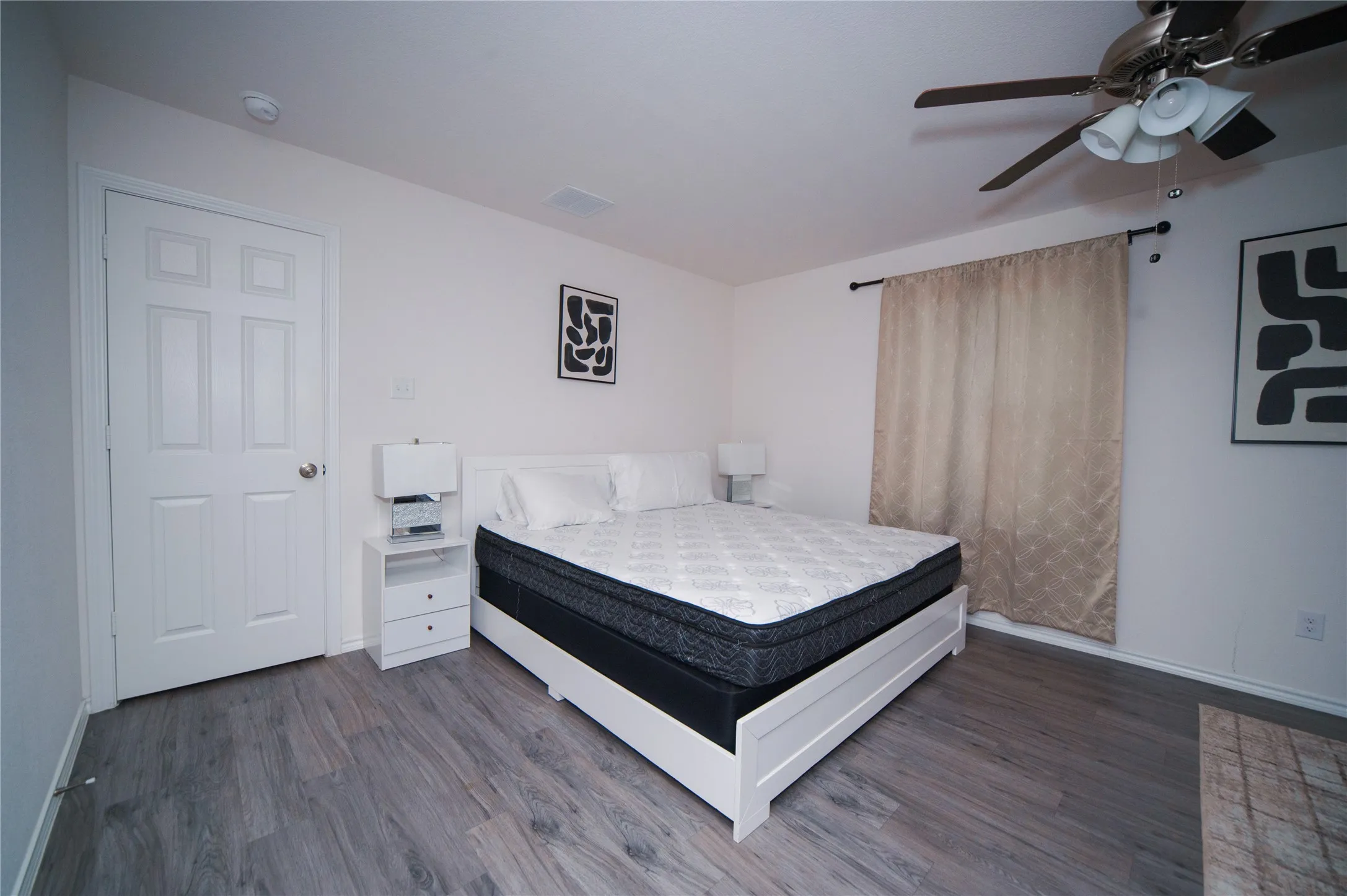 Wood-finish flooring with a ceiling fan light fixture