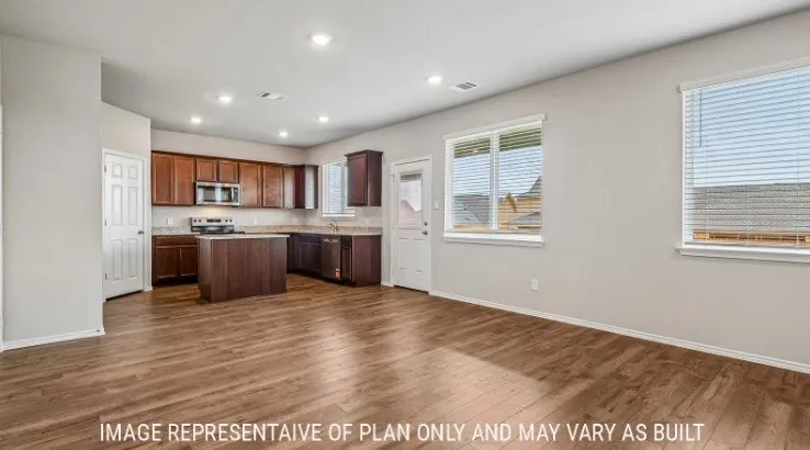 Wood-finish flooring throughout, recessed lighting, and a kitchen featuring dark wood cabinetry, a center island, and stainless steel appliances