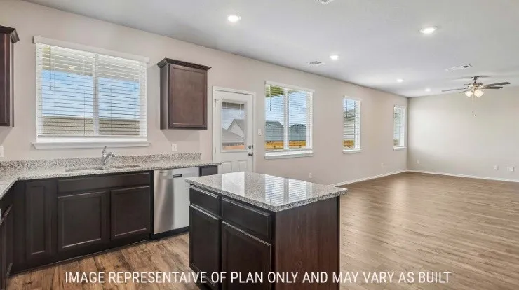 Kitchen with granite countertops, dark wood-finish cabinetry, stainless steel dishwasher, and a center island