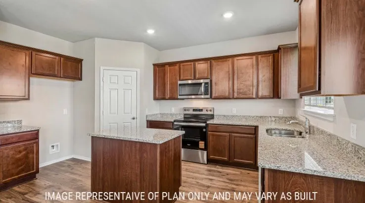 Kitchen featuring a central island, wood-finish cabinetry, granite countertops, stainless steel appliances, and recessed lighting