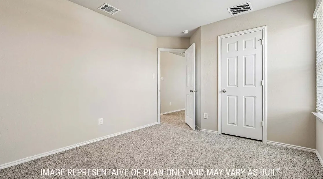 Wall-to-wall carpet, interior paneled doors, and light-toned wall finishes
