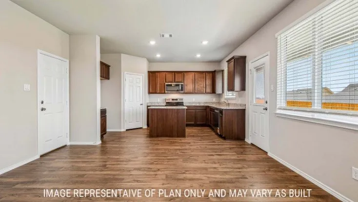 Wood-finish flooring throughout, kitchen with dark wood cabinetry, stainless steel appliances, and stone-look countertops