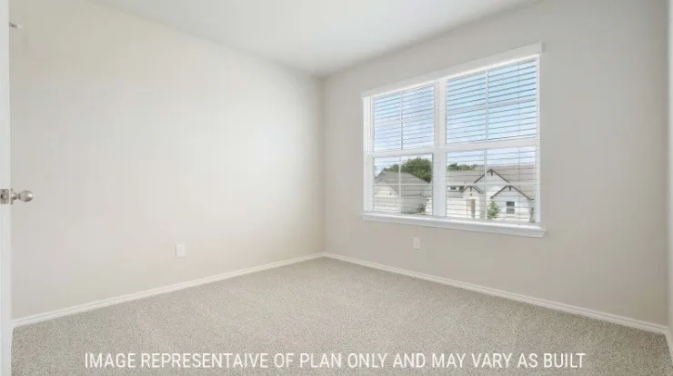 Carpeted flooring, neutral wall tones, white trim, and a window with blinds