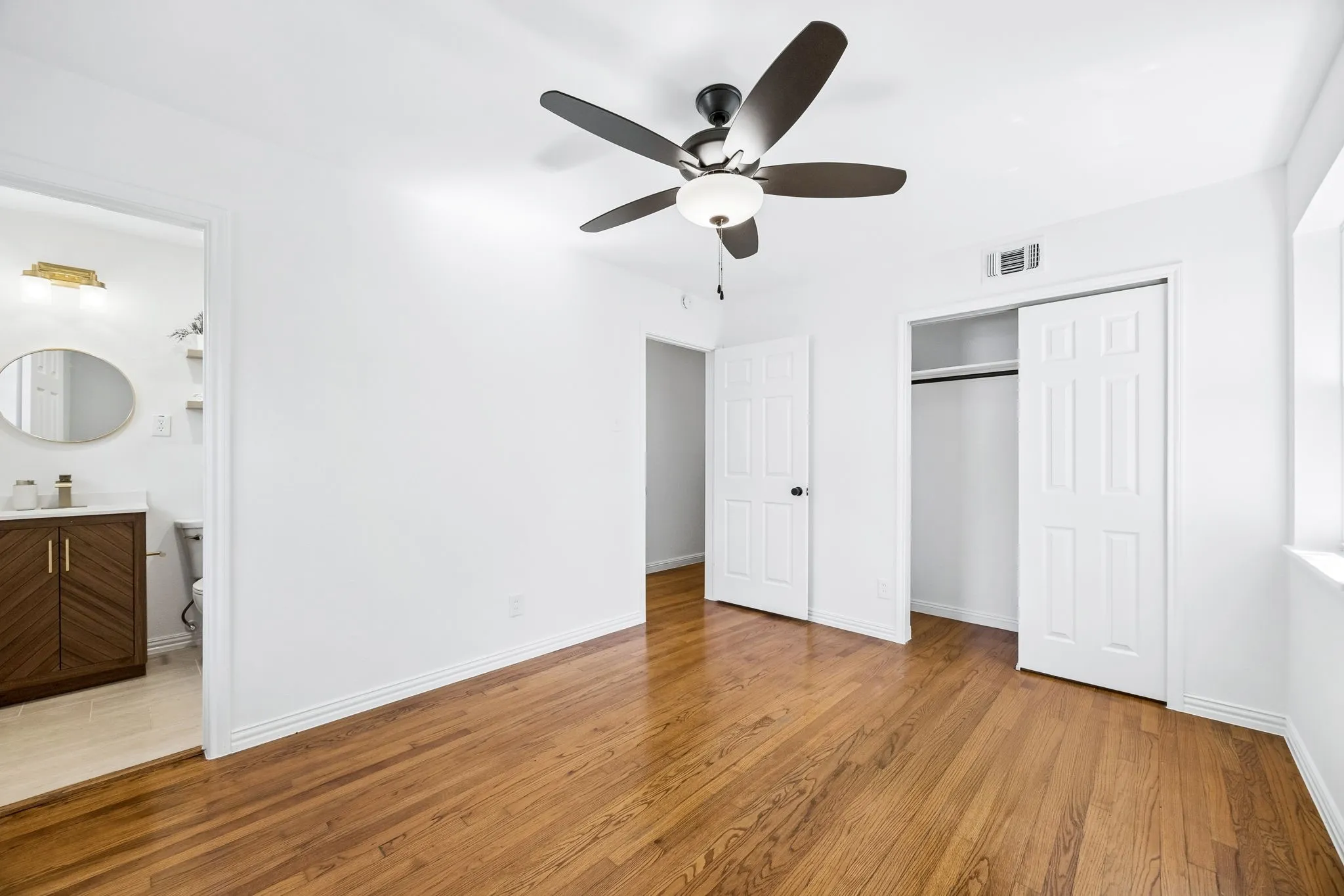 Large deep closet in this primary suite. Love the original floors that remind you of the beauty and quality of construction during  this era