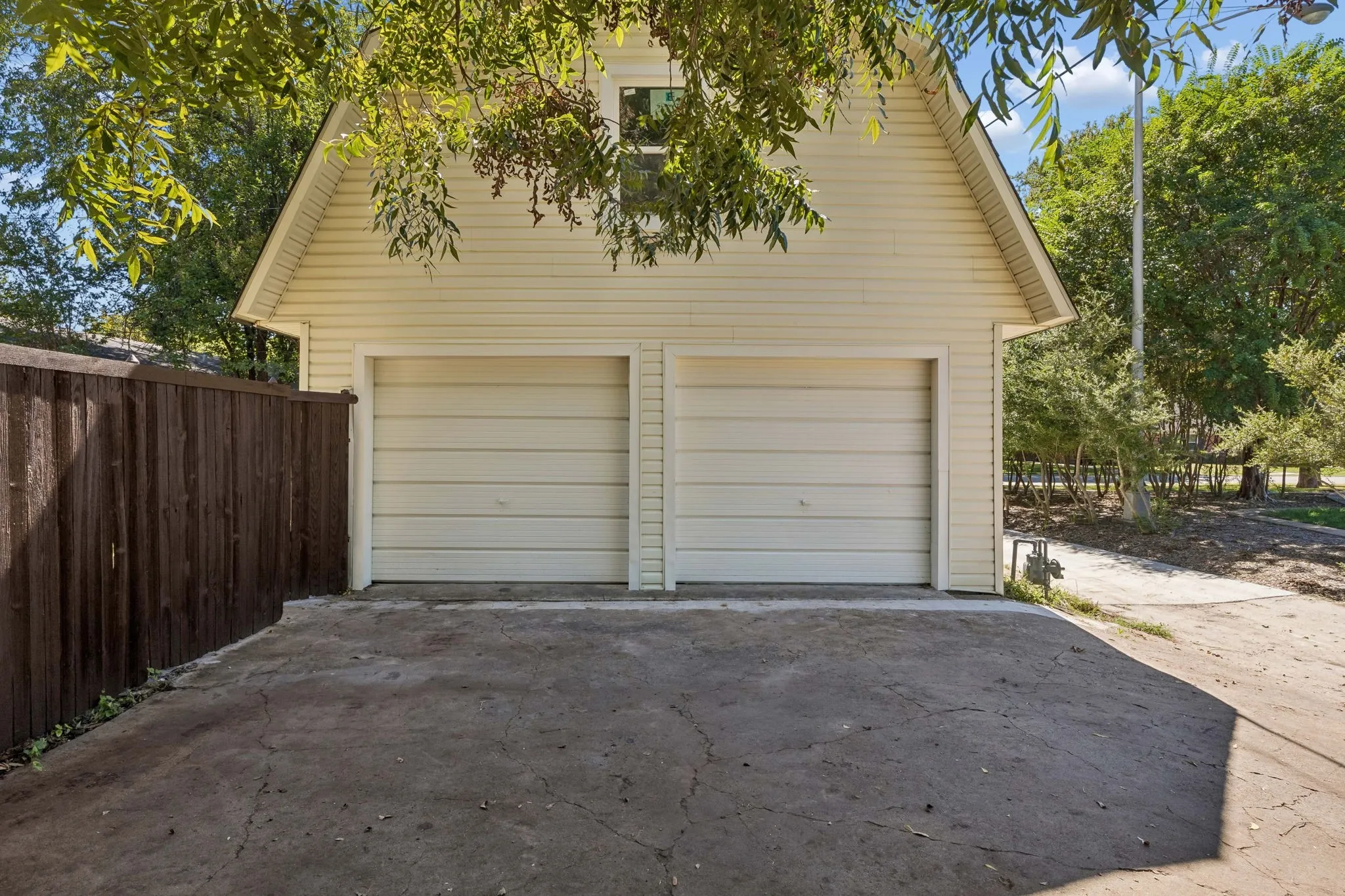 2 car detached garage with additional parking for 2 more cars.  Don't forget in front there is even more parking for 2 or more cars in the oversized driveway.    Front garage doors are faux doors with 3 additional feet of storage space