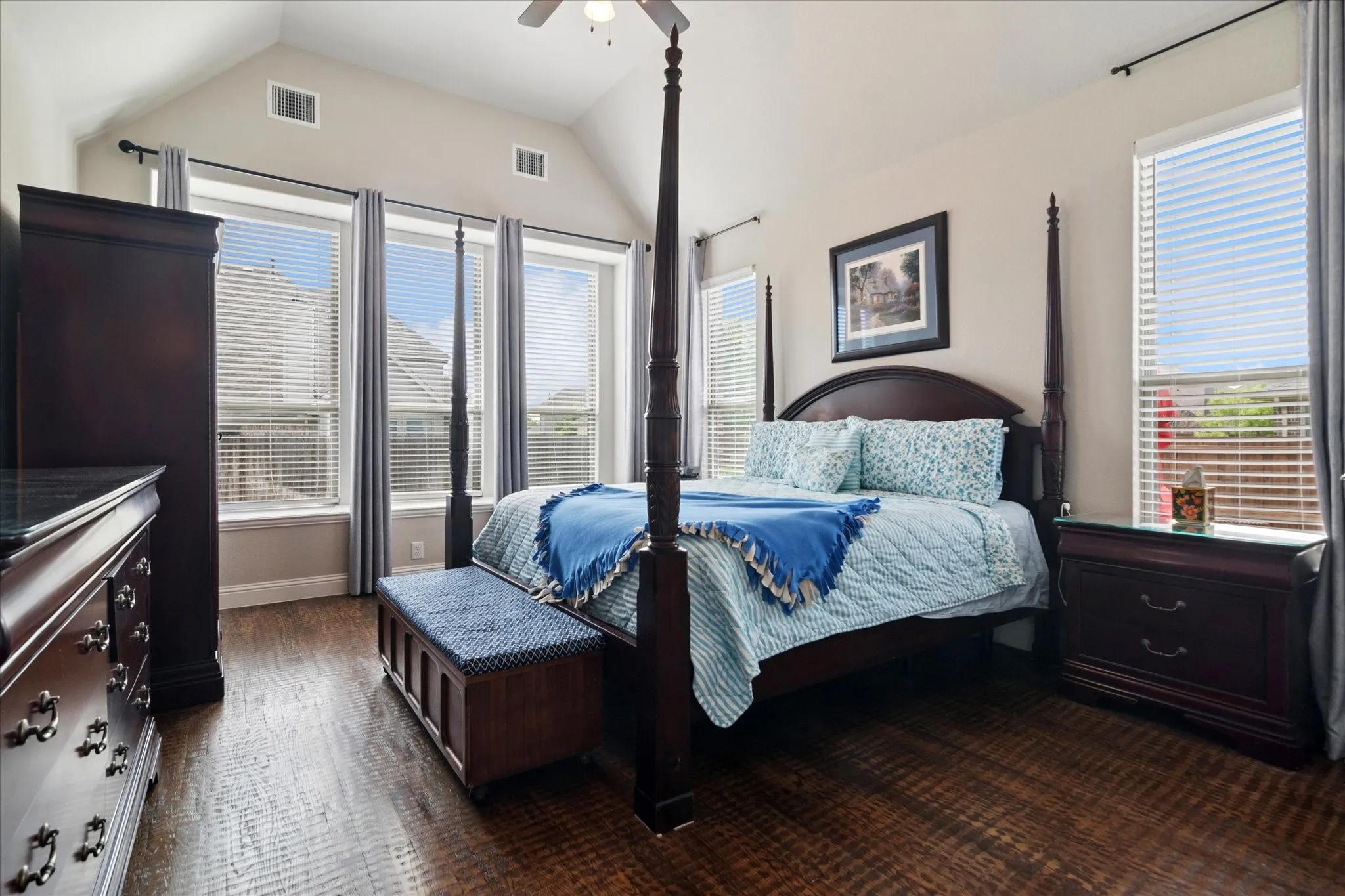 Vaulted ceiling with a ceiling fan, recessed lighting, and wood-finish flooring