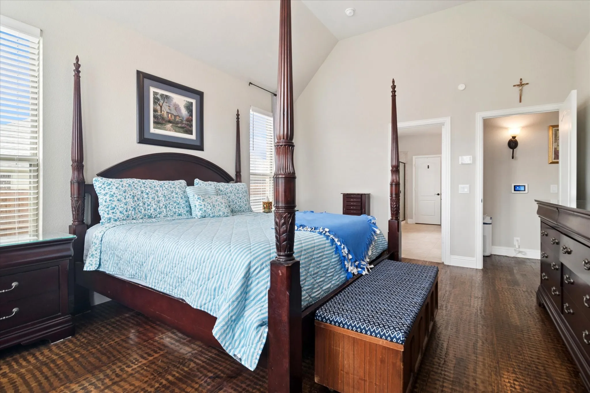 Vaulted ceiling, hard-surface flooring, and neutral wall tones