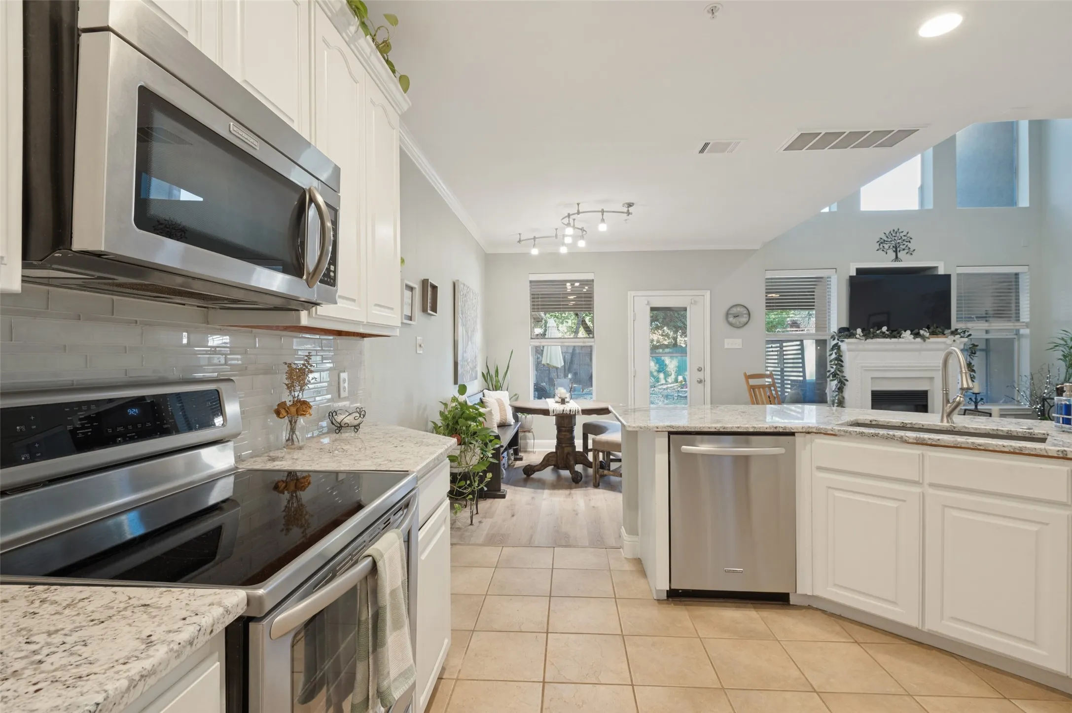 The kitchen opens to the dining, living and backyard
