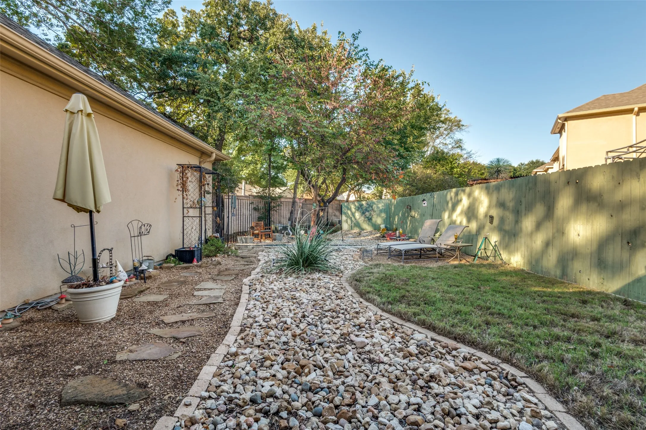 Backyard is nicely landscaped for low maintenance and relaxation