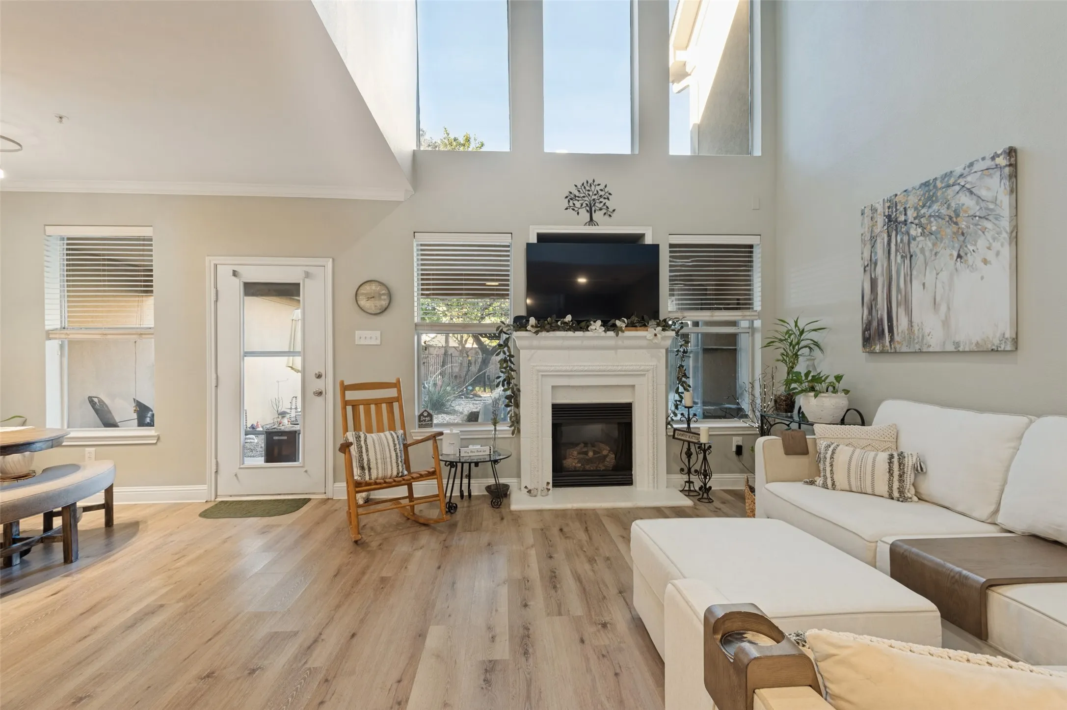 Tall ceilings, fireplace and cozy dining with lots of light