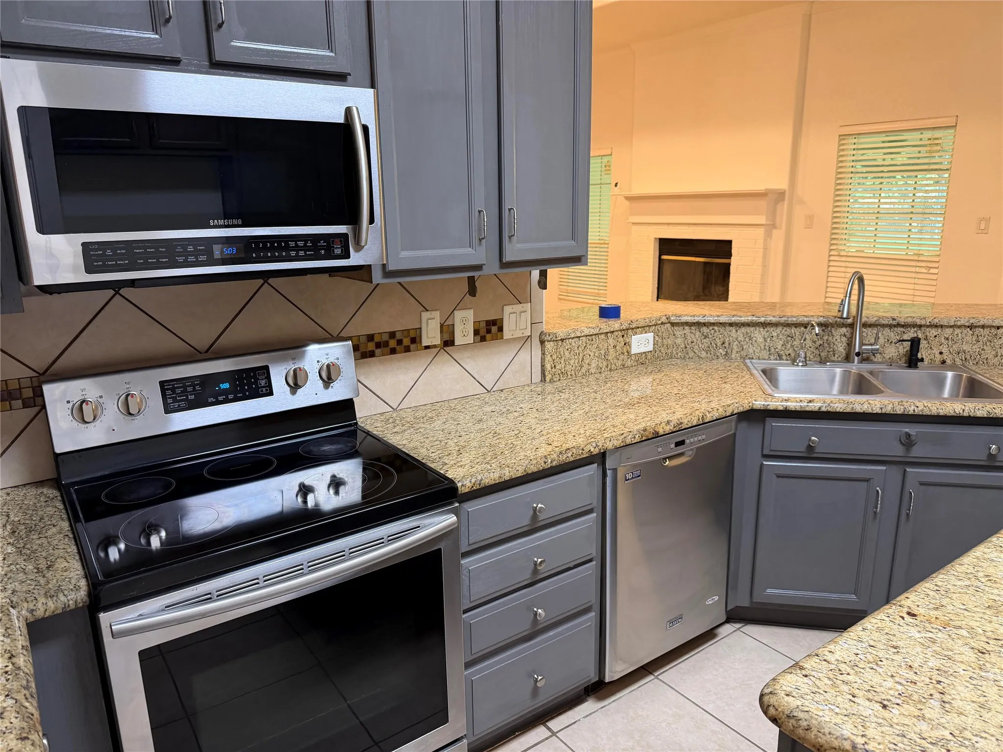 Beautiful Granite and backsplace with stainless steel appliances