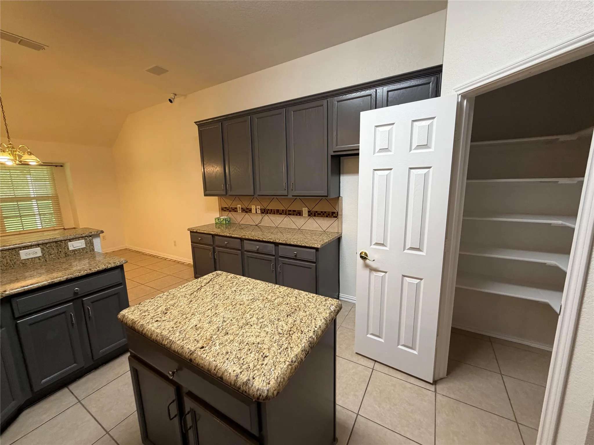 Beautiful Granite and backsplace with stainless steel appliances large Pantry