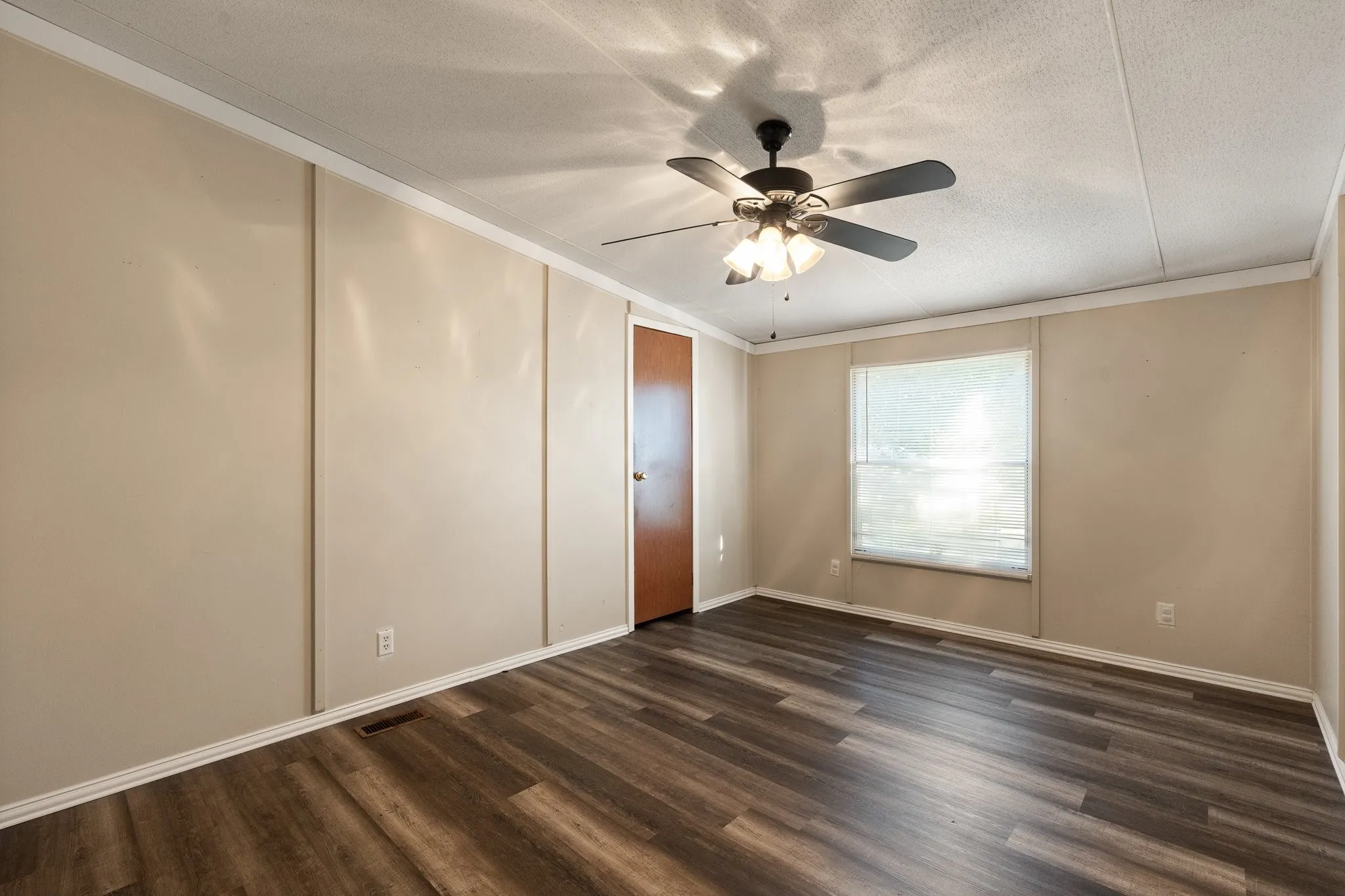 Bedroom #2 with walk in closet and ceiling fan.